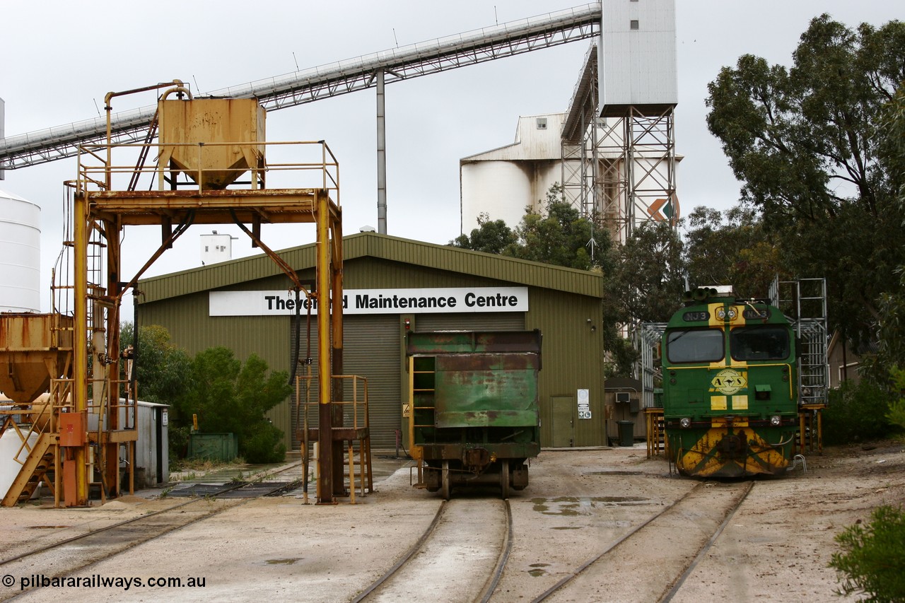 051102 6615
Thevenard Maintenance Centre overview, with NJ class Clyde Engineering EMD JL22C model unit NJ 3 serial 71-730, built in 1971 at Clyde's Granville NSW workshops, started out on the Central Australia Railway for the Commonwealth Railways before being transferred to the Eyre Peninsula system in 1981. Still in AN green but lettered for Australian Southern Railroad and a lone ENH type hopper standing around 'on-shed'. Behind the sanding plant and shed are the no longer rail serviced grain silos.
Keywords: NJ-class;NJ3;Clyde-Engineering-Granville-NSW;EMD;JL22C;71-730;
