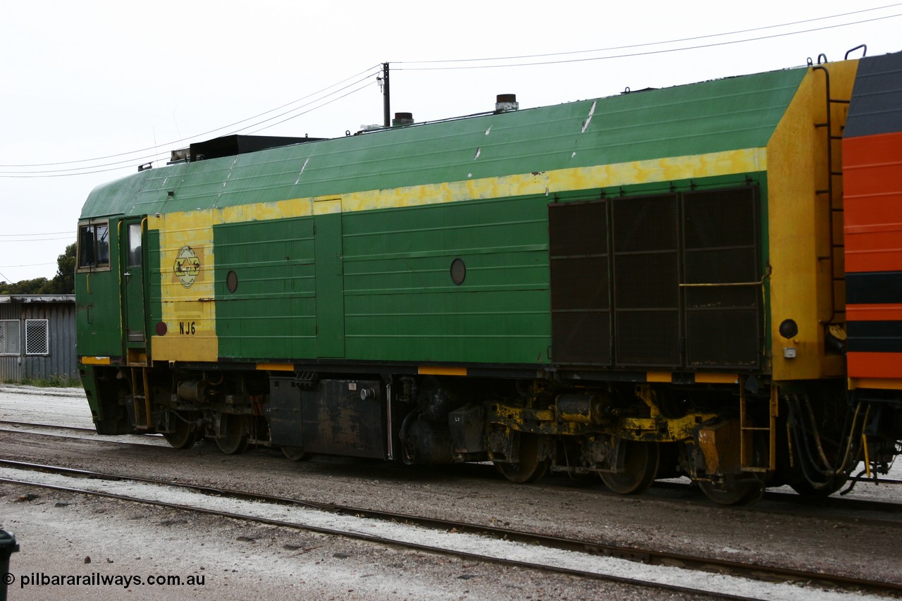 051102 6620
Thevenard, left hand side view of NJ class Clyde Engineering EMD JL22C model unit NJ 6 serial 71-733, built in 1971 at Clyde's Granville NSW workshops, started out on the Central Australia Railway for the Commonwealth Railways before being transferred to the Eyre Peninsula system in 1981. Still in AN green but lettered for Australian Southern Railroad. 
Keywords: NJ-class;NJ6;Clyde-Engineering-Granville-NSW;EMD;JL22C;71-733;