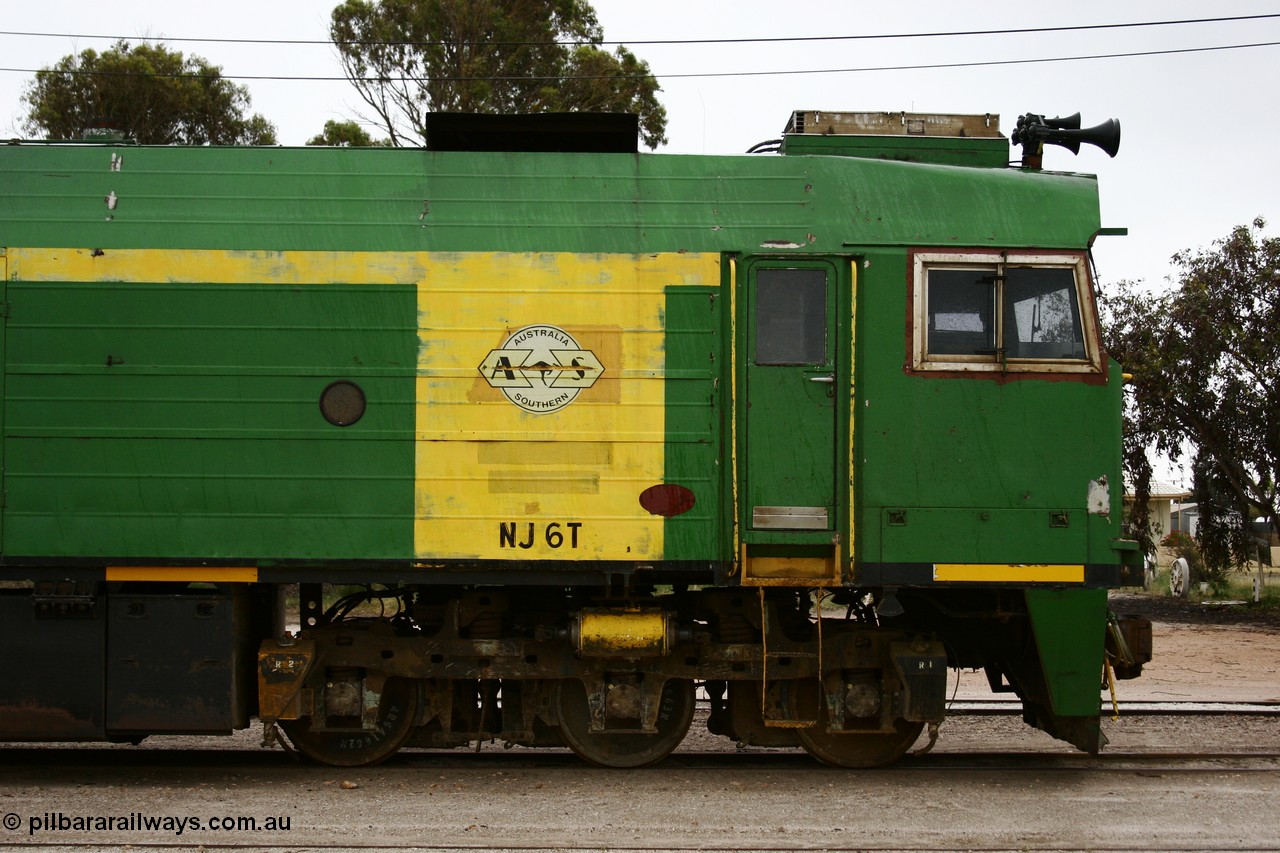 051102 6627
Thevenard, cab side view of NJ class Clyde Engineering EMD JL22C model unit NJ 6 serial 71-733, built in 1971 at Clyde's Granville NSW workshops, started out on the Central Australia Railway for the Commonwealth Railways before being transferred to the Eyre Peninsula system in 1981. Still in AN green but lettered for Australian Southern Railroad. 
Keywords: NJ-class;NJ6;Clyde-Engineering-Granville-NSW;EMD;JL22C;71-733;