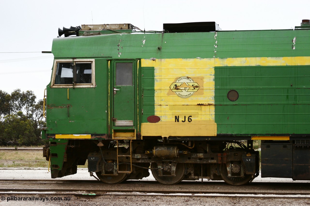 051102 6632
Thevenard, cab side view of NJ class Clyde Engineering EMD JL22C model unit NJ 6 serial 71-733, built in 1971 at Clyde's Granville NSW workshops, started out on the Central Australia Railway for the Commonwealth Railways before being transferred to the Eyre Peninsula system in 1981. Still in AN green but lettered for Australian Southern Railroad. 
Keywords: NJ-class;NJ6;Clyde-Engineering-Granville-NSW;EMD;JL22C;71-733;