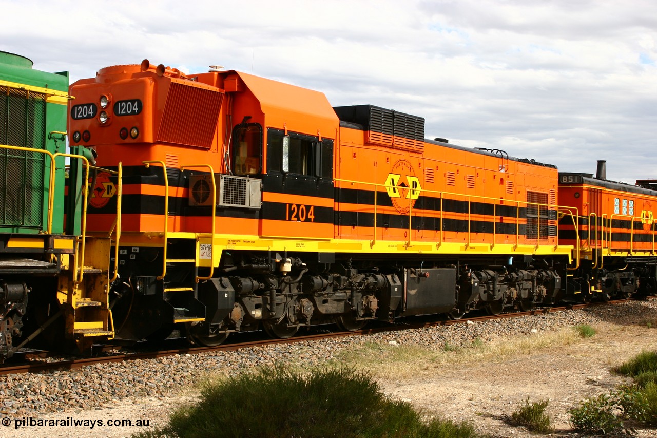 060108 2063
Lock, ARG 1200 class unit 1204, a Clyde Engineering EMD model G12C serial 65-428, final of fourteen originally built between 1960-65 for WAGR as their A class A 1514, fitted with dynamic brakes and financed by Western Mining Corporation, started on the Eyre Peninsula in August 2004.
Keywords: 1200-class;1204;Clyde-Engineering-Granville-NSW;EMD;G12C;65-428;A-class;A1514;