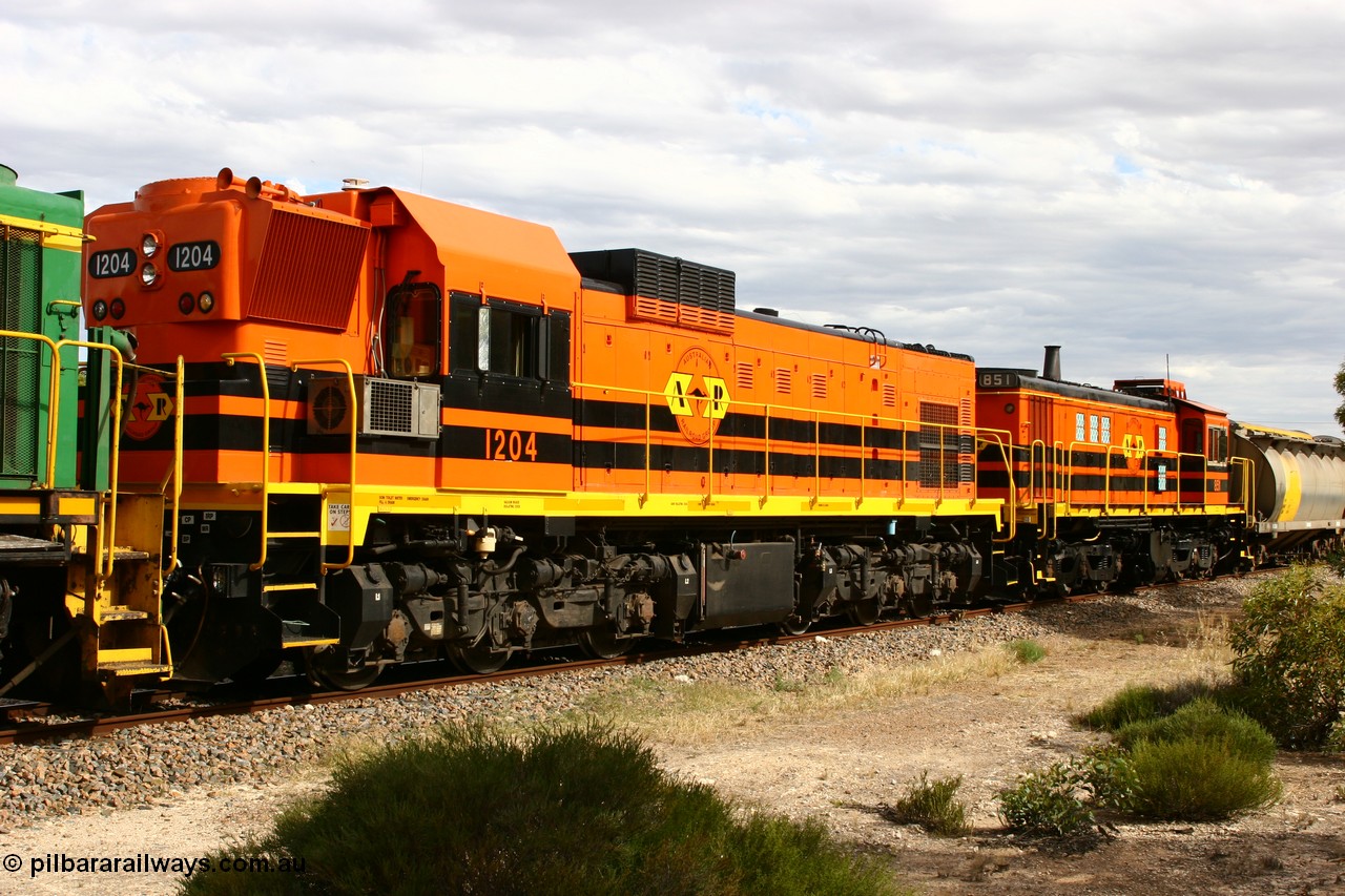 060108 2064
Lock, ARG 1200 class unit 1204, a Clyde Engineering EMD model G12C serial 65-428, final of fourteen originally built between 1960-65 for WAGR as their A class A 1514, fitted with dynamic brakes and financed by Western Mining Corporation, started on the Eyre Peninsula in August 2004.
Keywords: 1200-class;1204;Clyde-Engineering-Granville-NSW;EMD;G12C;65-428;A-class;A1514;
