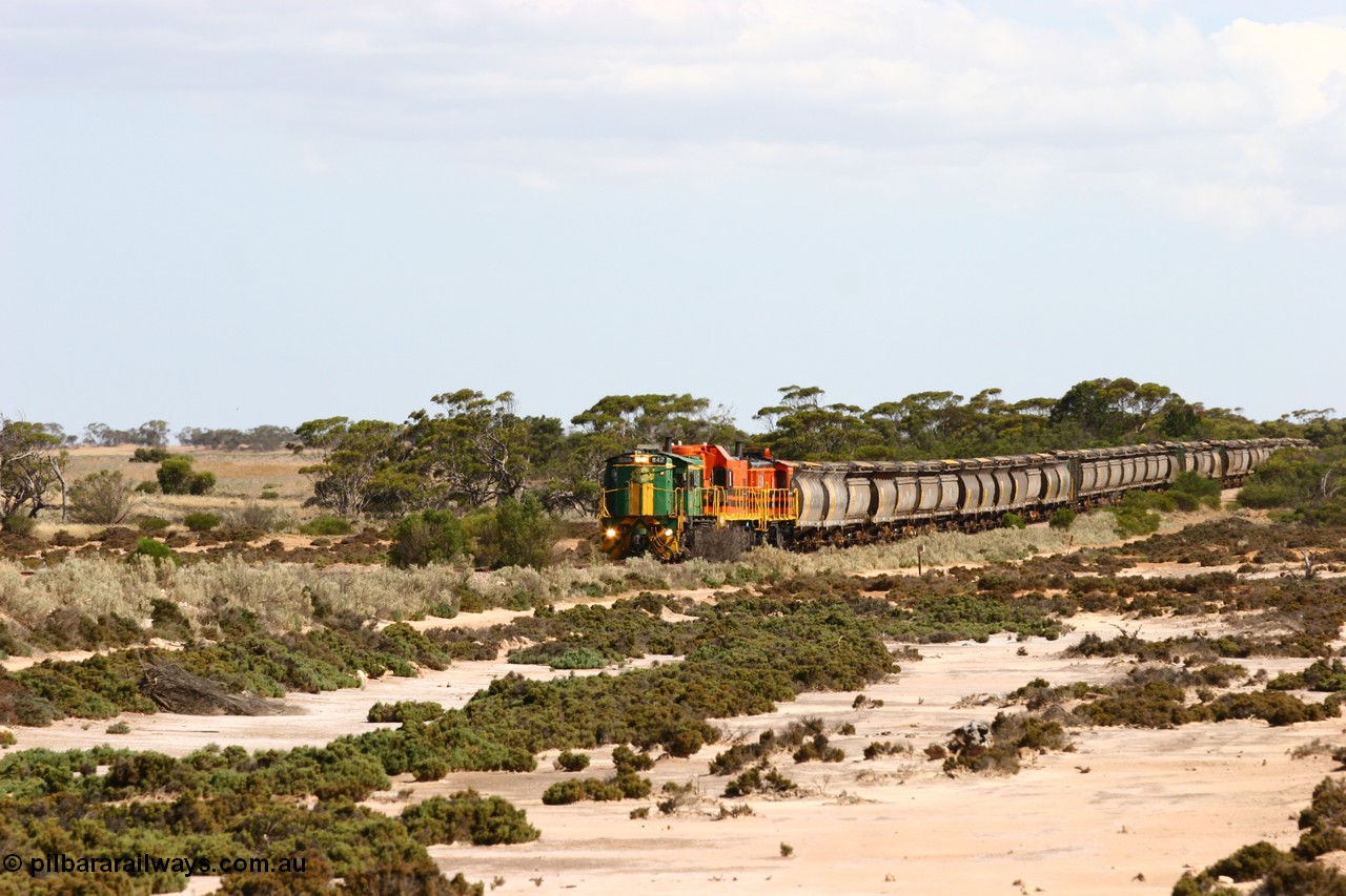 060109 2090
Kyancutta at the 198 km, ASR 830 class unit 842, an AE Goodwin built ALCo DL531 model loco serial 84140 leads EMD unit 1204 due to air-conditioning trouble and sister ALCo 851 across a dry salt soak with a north bound empty grain train. 9th January 2006.
Keywords: 830-class;842;AE-Goodwin;ALCo;DL531;84140;