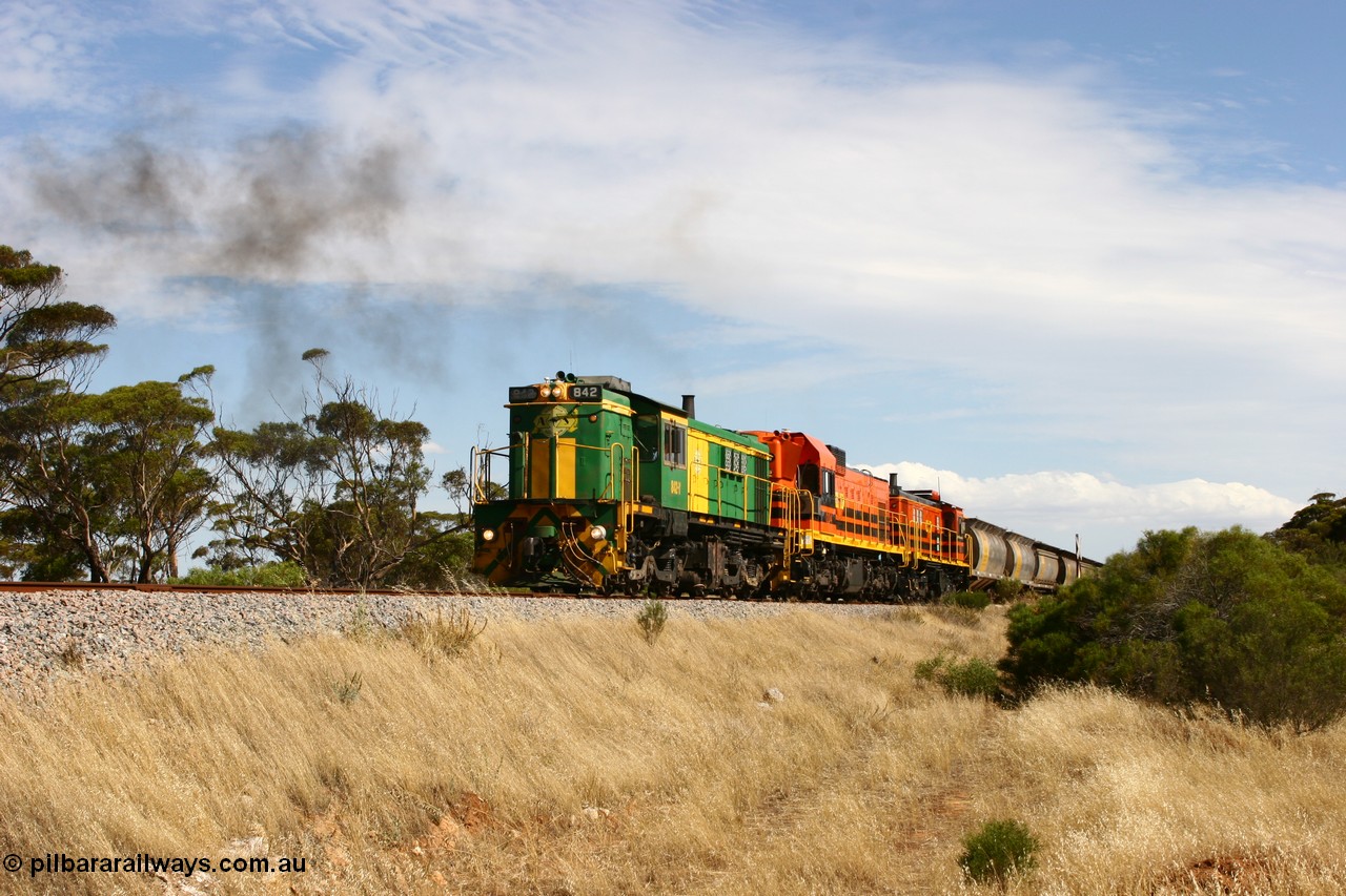 060109 2107
Kyancutta, Kyancutta Tanks Rd grade crossing, ASR 830 class unit 842, an AE Goodwin built ALCo DL531 model loco serial 84140 leads EMD unit 1204 due to air-conditioning trouble and sister ALCo 851 lift the empty north bound grain train away from crew change. 9th January 2006.
Keywords: 830-class;842;AE-Goodwin;ALCo;DL531;84140;