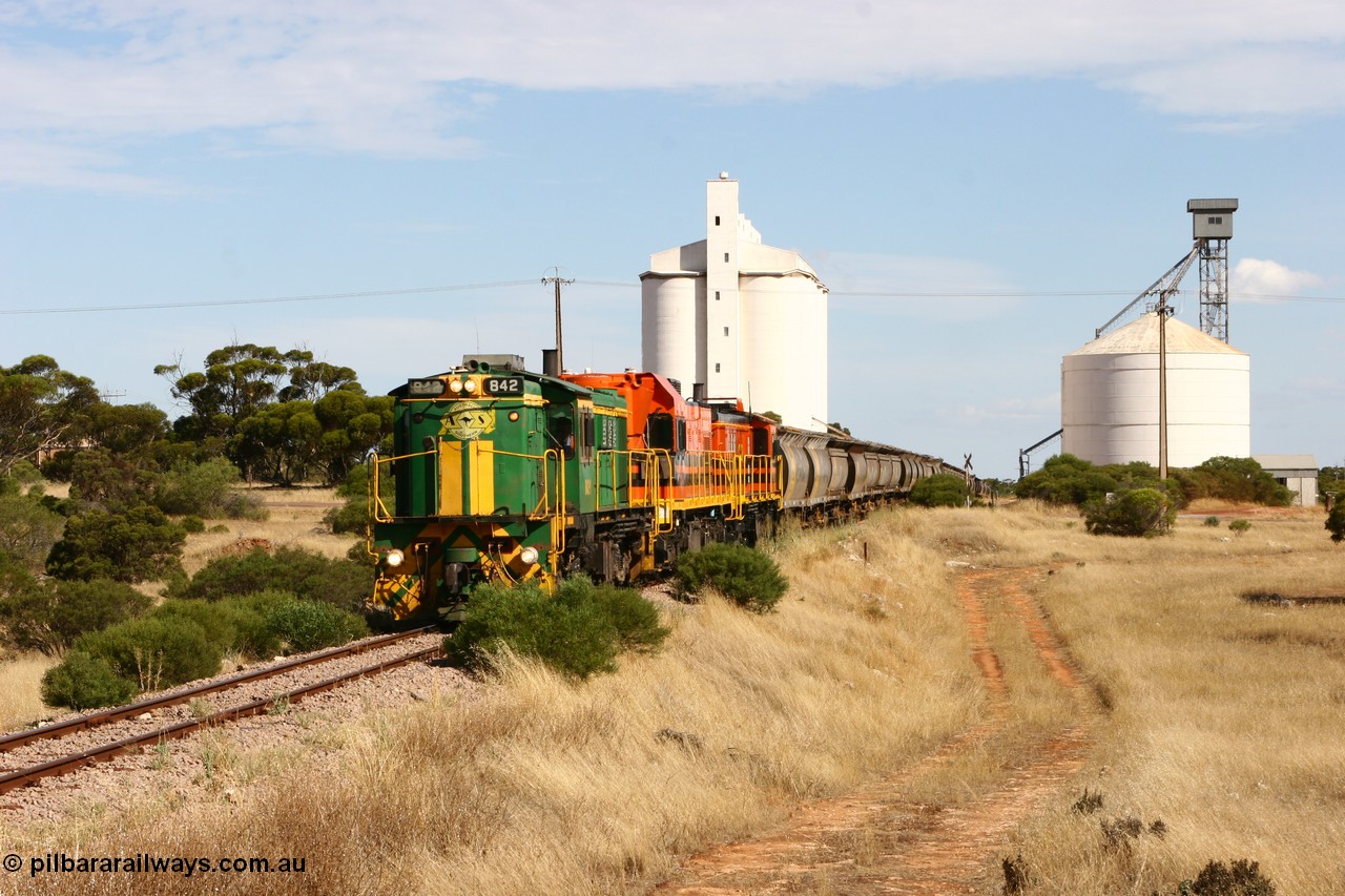 060109 2112
Kyancutta, ASR 830 class unit 842, an AE Goodwin built ALCo DL531 model loco serial 84140 leads EMD unit 1204 due to air-conditioning trouble and sister ALCo 851 as they shunt across Museum Terrace to place empty grain waggons on the silo loop. 9th January 2006.
Keywords: 830-class;842;AE-Goodwin;ALCo;DL531;84140;