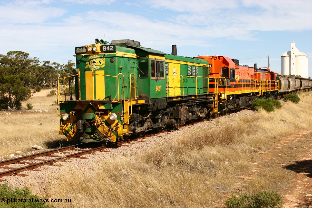 060109 2114
Kyancutta, ASR 830 class unit 842, an AE Goodwin built ALCo DL531 model loco serial 84140 leads EMD unit 1204 due to air-conditioning trouble and sister ALCo 851 as they shunt across Museum Terrace to place empty grain waggons on the silo loop. 9th January 2006.
Keywords: 830-class;842;AE-Goodwin;ALCo;DL531;84140;