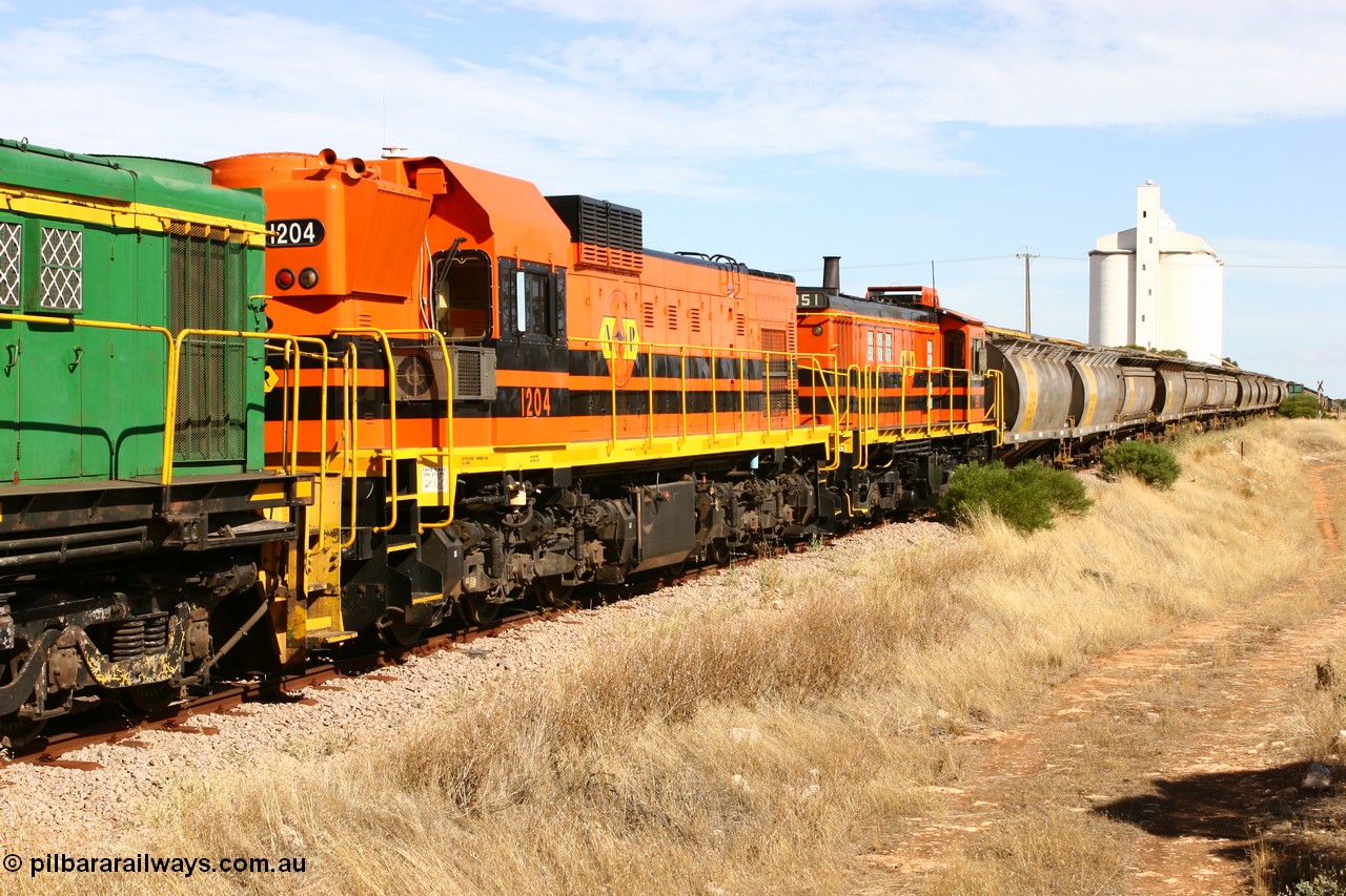 060109 2116
Kyancutta, ARG's Clyde Engineering built EMD G12C 1200 class unit 1204 serial 65-428 was originally built for the WAGR as their A class unit A 1514. Due to air-conditioning trouble it is in the shafts as they shunt across Museum Terrace to place empty grain waggons on the silo loop. 9th January 2006.
Keywords: 1200-class;1204;Clyde-Engineering-Granville-NSW;EMD;G12C;65-428;A-class;A1514;