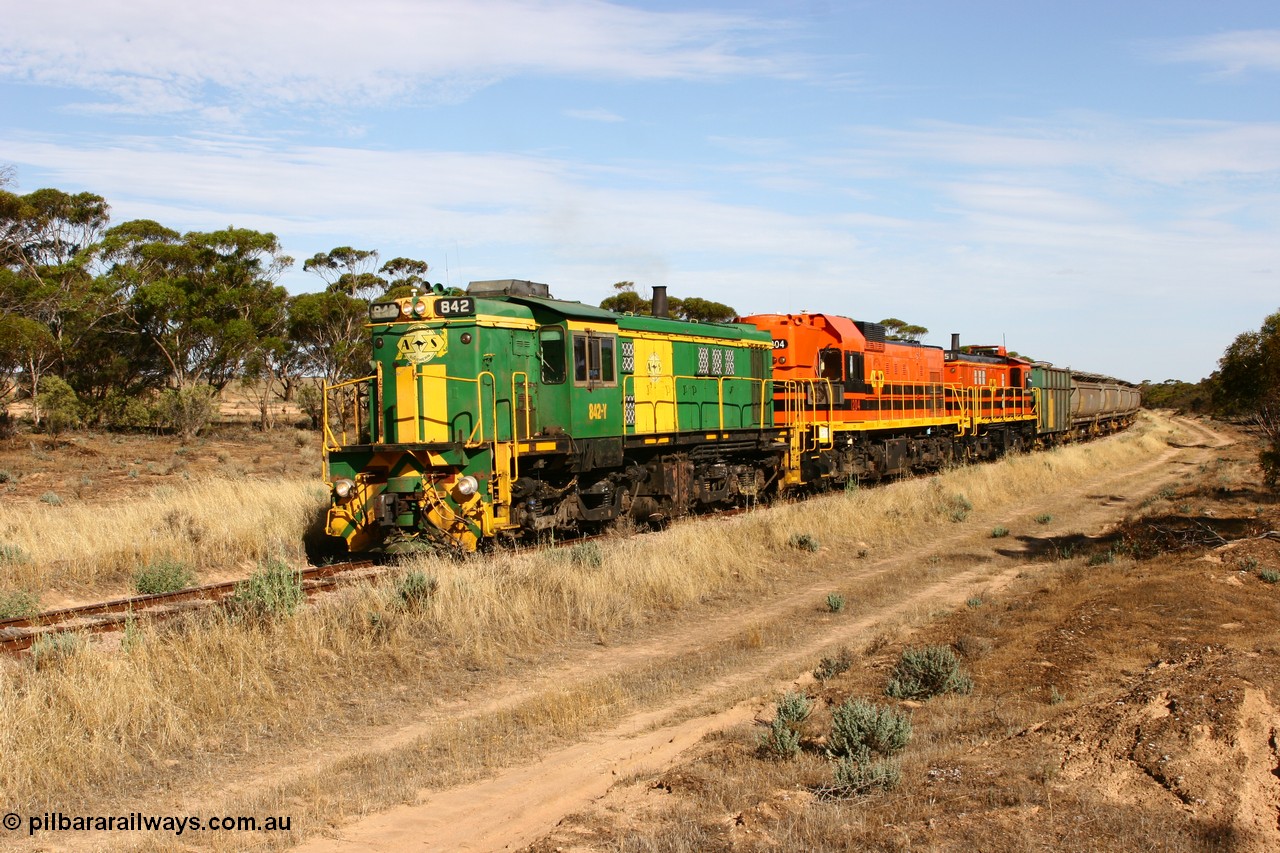 060109 2142
Wannamana, [url=https://goo.gl/maps/43EOs]on the curve[/url] 2 km north of the former station site empty train lead by ASR 830 class unit 842, an AE Goodwin built ALCo DL531 model loco serial 84140 with an EMD 1200 class and a sister ALCo unit. 9th January 2006.
Keywords: 830-class;842;AE-Goodwin;ALCo;DL531;84140;