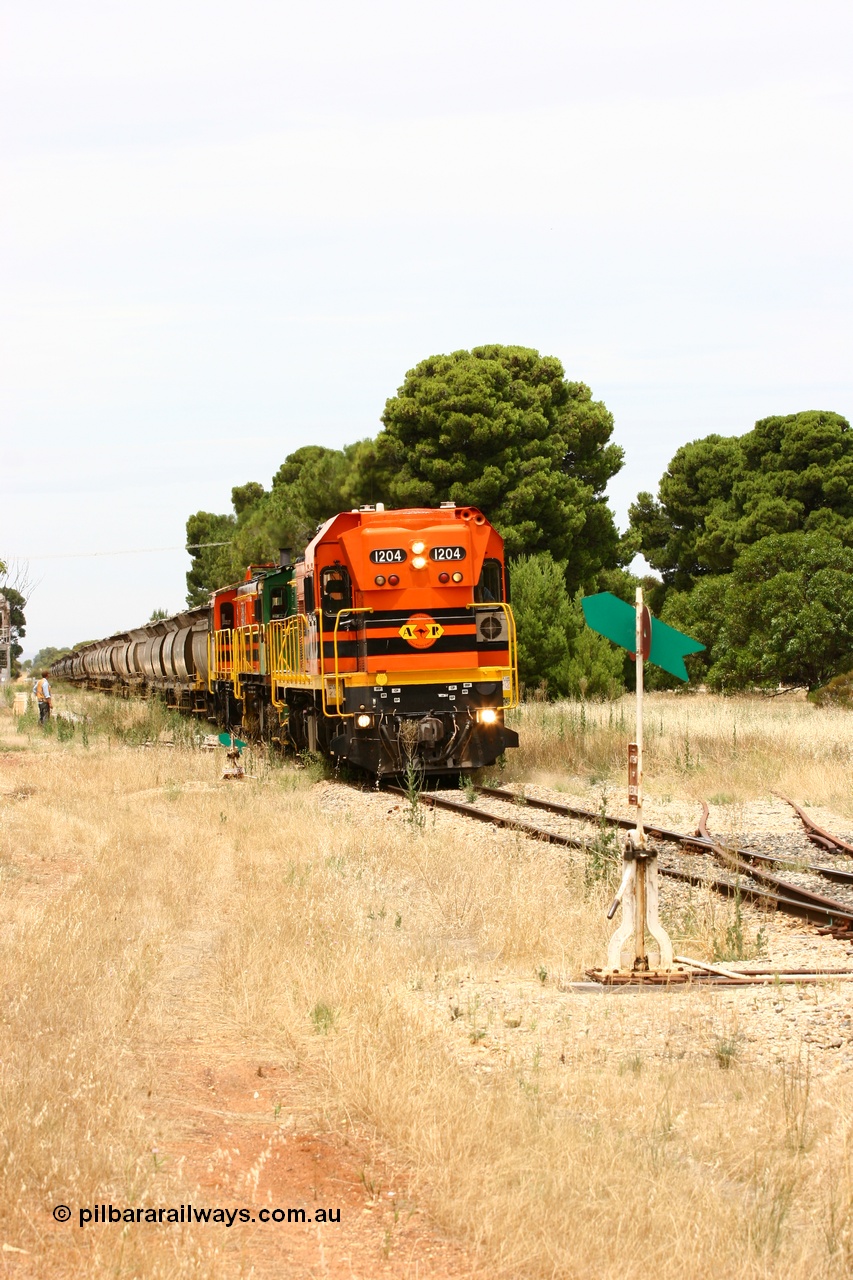 060110 2191
Yeelanna, the second person watches ARG 1200 class unit 1204, a Clyde Engineering EMD model G12C serial 65-428, originally built for the WAGR as the final unit of fourteen A class locomotives in 1965 and sent to the Eyre Peninsula in July 2004 as it shunts forward to cut out the empty cars for the siding. [url=https://goo.gl/maps/1JetzWBTGAw]Approx. location of image[/url].
Keywords: 1200-class;1204;Clyde-Engineering-Granville-NSW;EMD;G12C;65-428;A-class;A1514;