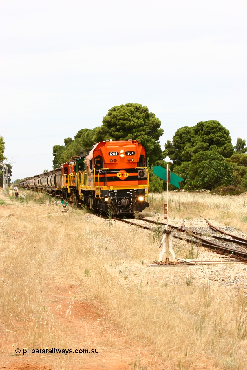 060110 2192
Yeelanna, the second person watches ARG 1200 class unit 1204, a Clyde Engineering EMD model G12C serial 65-428, originally built for the WAGR as the final unit of fourteen A class locomotives in 1965 and sent to the Eyre Peninsula in July 2004 as it shunts forward to cut out the empty cars for the siding. [url=https://goo.gl/maps/1JetzWBTGAw]Approx. location of image[/url].
Keywords: 1200-class;1204;Clyde-Engineering-Granville-NSW;EMD;G12C;65-428;A-class;A1514;
