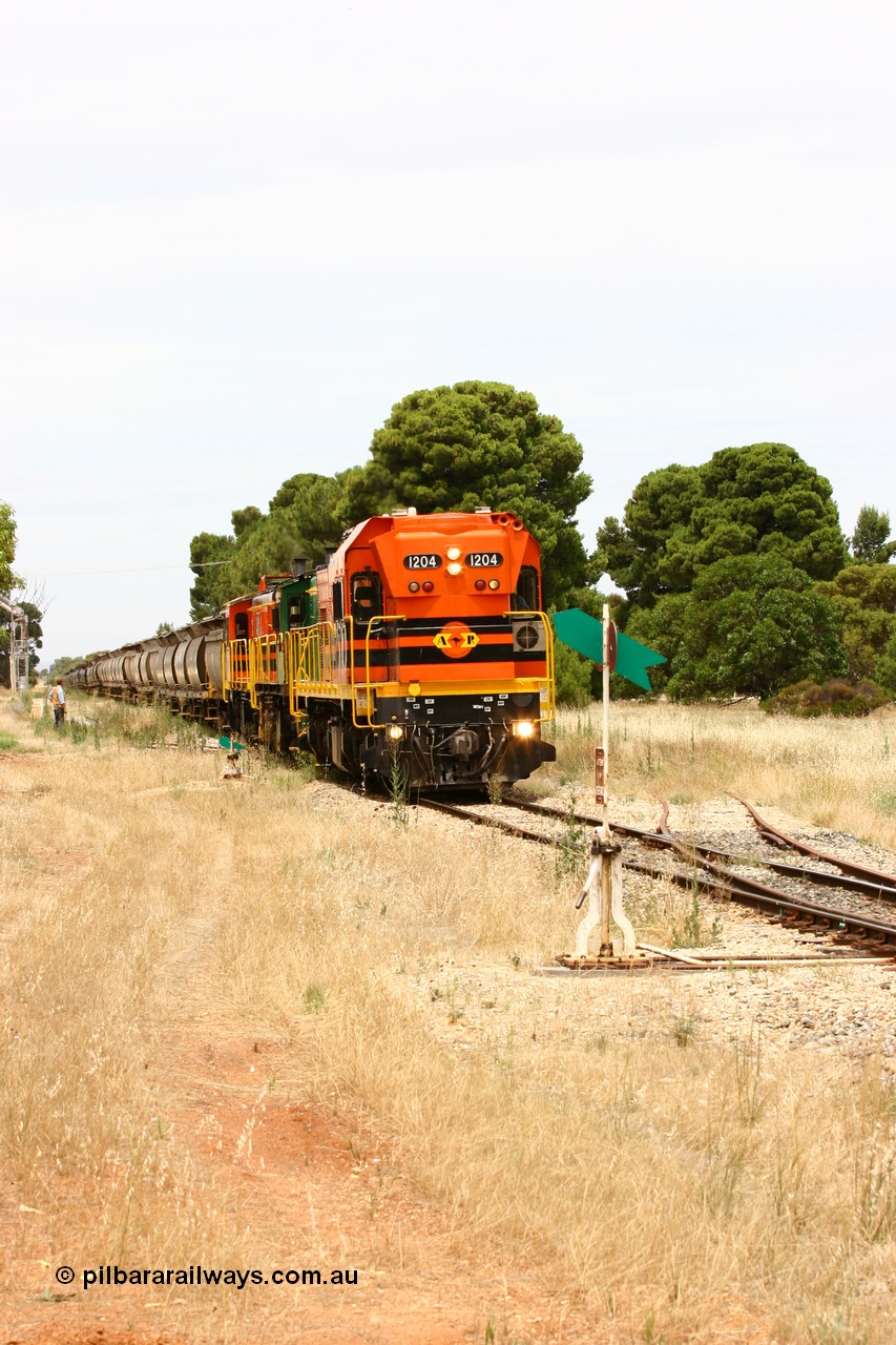 060110 2193
Yeelanna, the second person watches ARG 1200 class unit 1204, a Clyde Engineering EMD model G12C serial 65-428, originally built for the WAGR as the final unit of fourteen A class locomotives in 1965 and sent to the Eyre Peninsula in July 2004 as it shunts forward to cut out the empty cars for the siding. [url=https://goo.gl/maps/1JetzWBTGAw]Approx. location of image[/url].
Keywords: 1200-class;1204;Clyde-Engineering-Granville-NSW;EMD;G12C;65-428;A-class;A1514;