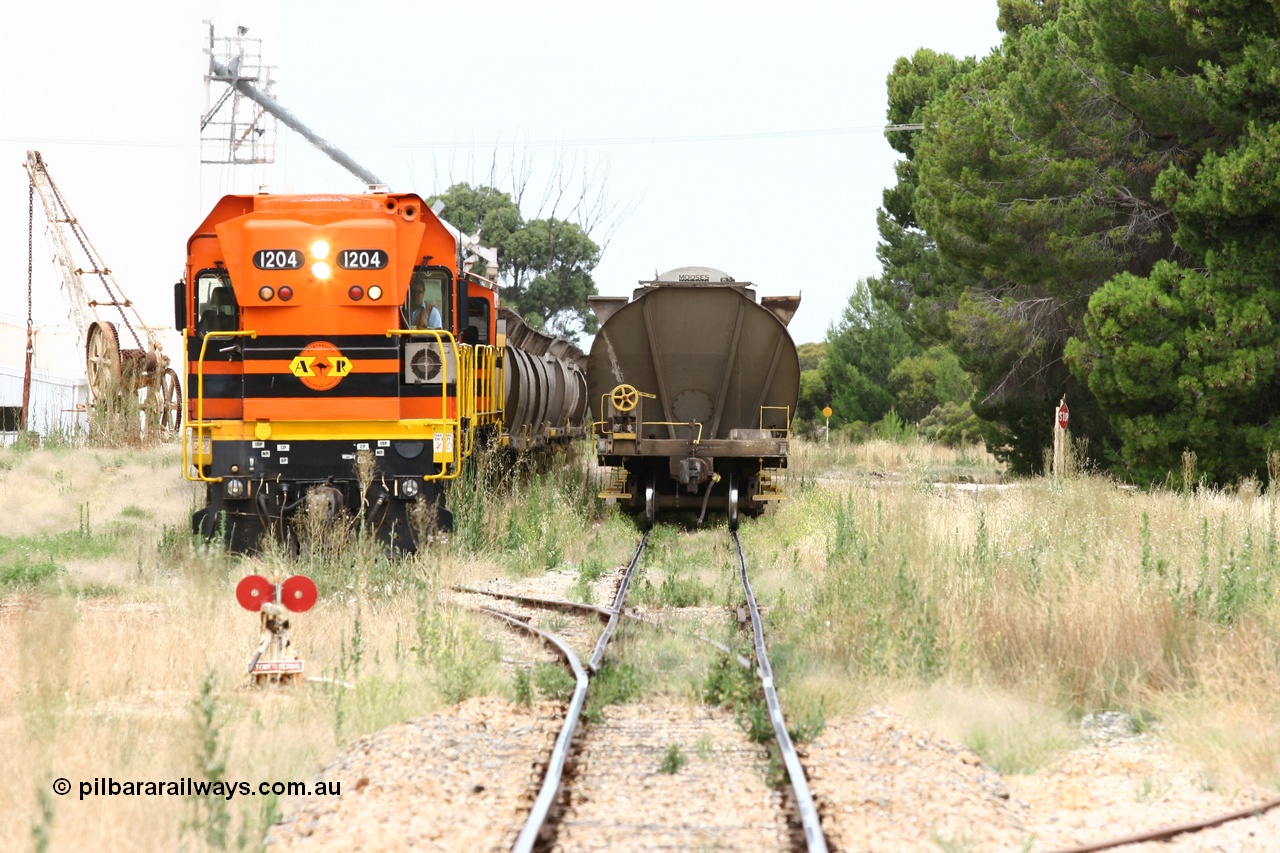 060110 2200
Yeelanna, ARG 1200 class unit 1204, a Clyde Engineering EMD model G12C serial 65-428, originally built for the WAGR as the final unit of fourteen A class locomotives in 1965 and sent to the Eyre Peninsula in July 2004 stands with a rake of waggons into the grain siding with the 5 ton crane also visible as the locos as cut off. [url=https://goo.gl/maps/1JetzWBTGAw]Approx. location of image[/url].
Keywords: 1200-class;1204;Clyde-Engineering-Granville-NSW;EMD;G12C;65-428;A-class;A1514;