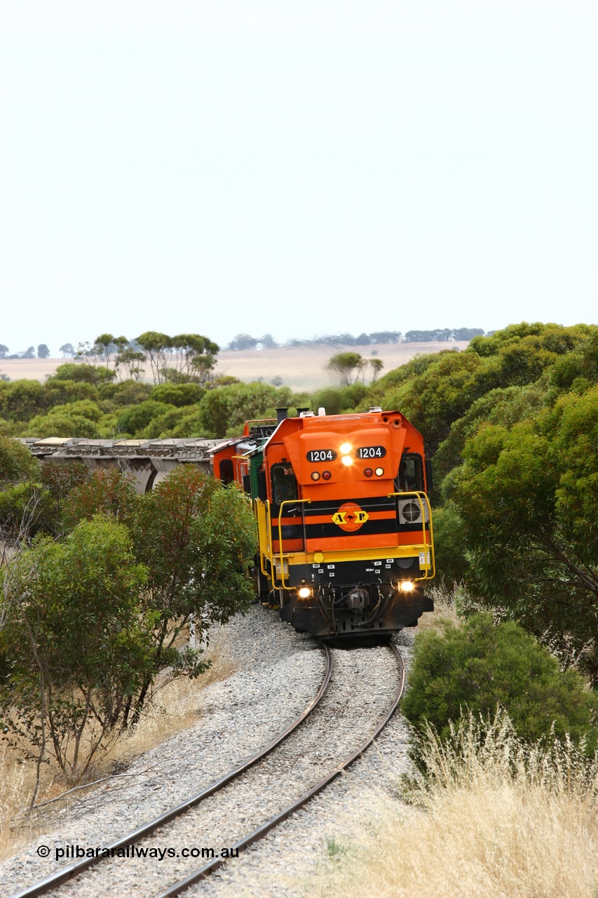 060110 2208
On the curve near the 85 km between Yeelanna and Karkoo, ARG 1200 class unit 1204, a Clyde Engineering EMD model G12C serial 65-428, originally built for the WAGR as the final unit of fourteen A class locomotives in 1965 and sent to the Eyre Peninsula in July 2004 leads an empty grain train. [url=https://goo.gl/maps/7kwfXBE6nS12]Approx. location of image[/url].
Keywords: 1200-class;1204;Clyde-Engineering-Granville-NSW;EMD;G12C;65-428;A-class;A1514;