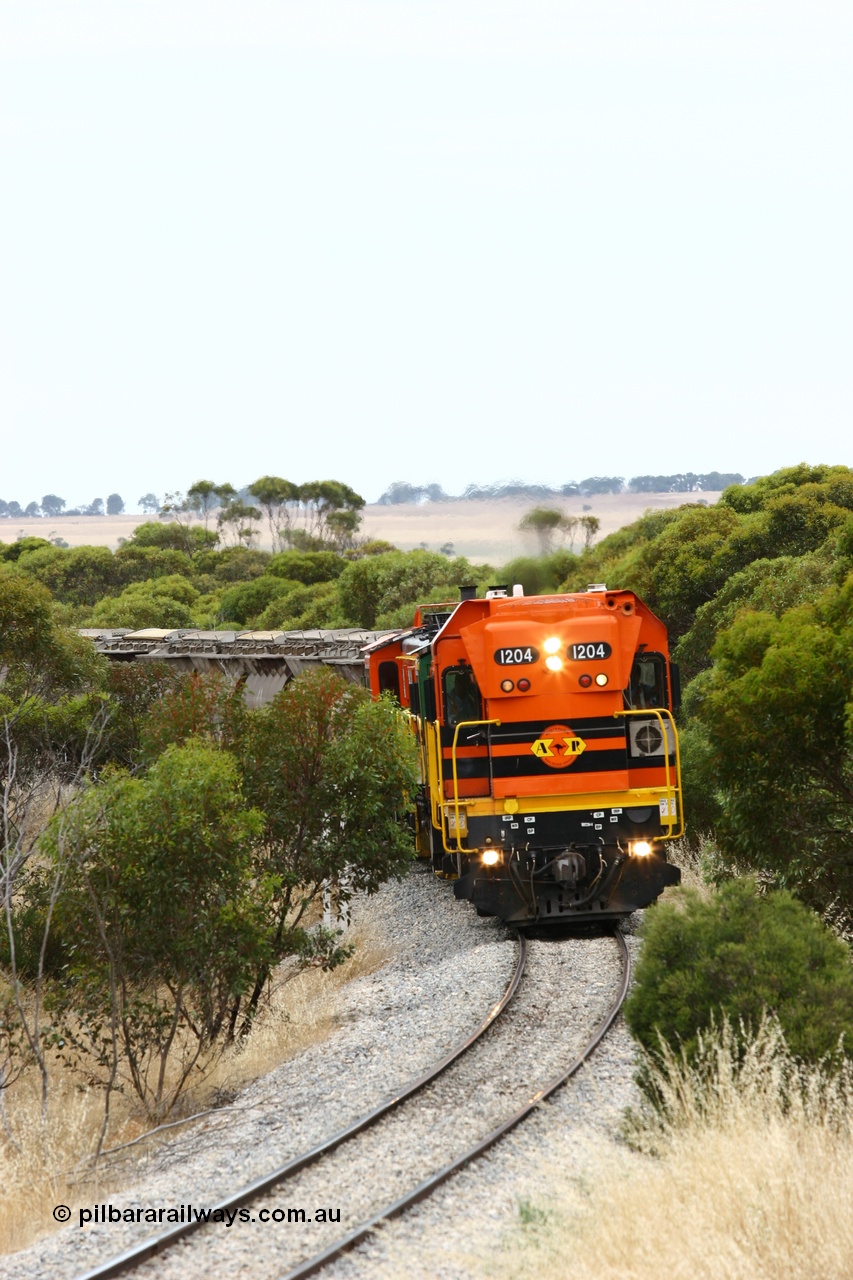 060110 2209
On the curve near the 85 km between Yeelanna and Karkoo, ARG 1200 class unit 1204, a Clyde Engineering EMD model G12C serial 65-428, originally built for the WAGR as the final unit of fourteen A class locomotives in 1965 and sent to the Eyre Peninsula in July 2004 leads an empty grain train. [url=https://goo.gl/maps/7kwfXBE6nS12]Approx. location of image[/url].
Keywords: 1200-class;1204;Clyde-Engineering-Granville-NSW;EMD;G12C;65-428;A-class;A1514;