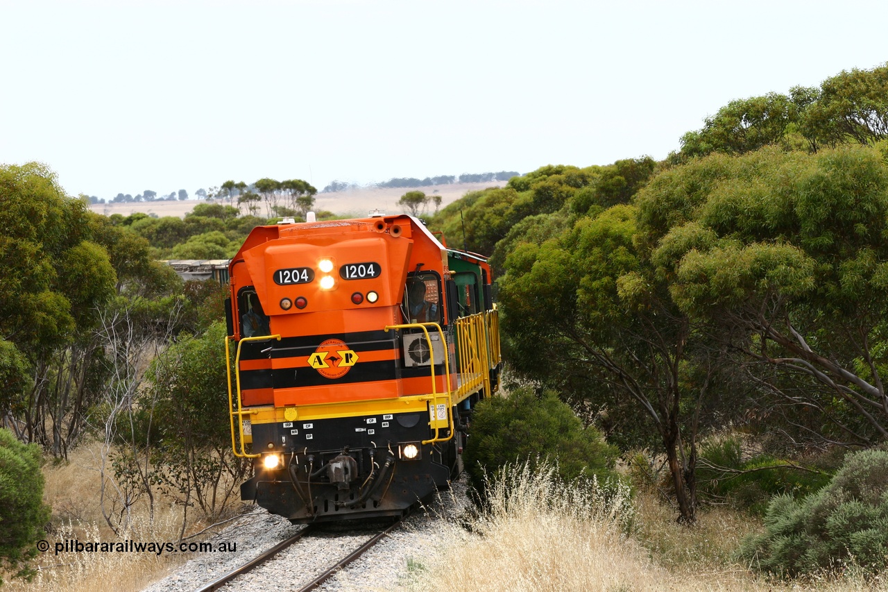 060110 2210
On the curve near the 85 km between Yeelanna and Karkoo, ARG 1200 class unit 1204, a Clyde Engineering EMD model G12C serial 65-428, originally built for the WAGR as the final unit of fourteen A class locomotives in 1965 and sent to the Eyre Peninsula in July 2004 leads an empty grain train. [url=https://goo.gl/maps/7kwfXBE6nS12]Approx. location of image[/url].
Keywords: 1200-class;1204;Clyde-Engineering-Granville-NSW;EMD;G12C;65-428;A-class;A1514;