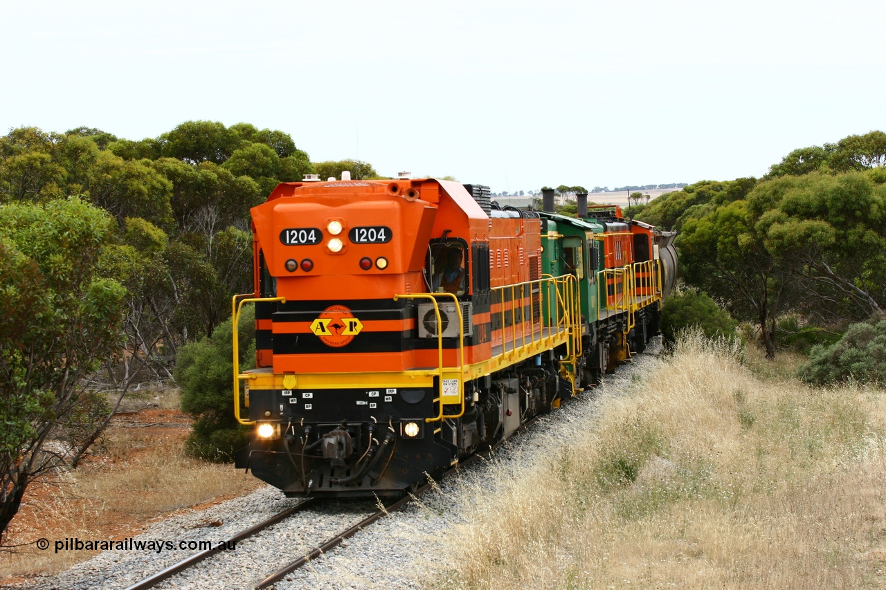 060110 2213
On the curve near the 85 km between Yeelanna and Karkoo, ARG 1200 class unit 1204, a Clyde Engineering EMD model G12C serial 65-428, originally built for the WAGR as the final unit of fourteen A class locomotives in 1965 and sent to the Eyre Peninsula in July 2004 leads an empty grain train. [url=https://goo.gl/maps/7kwfXBE6nS12]Approx. location of image[/url].
Keywords: 1200-class;1204;Clyde-Engineering-Granville-NSW;EMD;G12C;65-428;A-class;A1514;