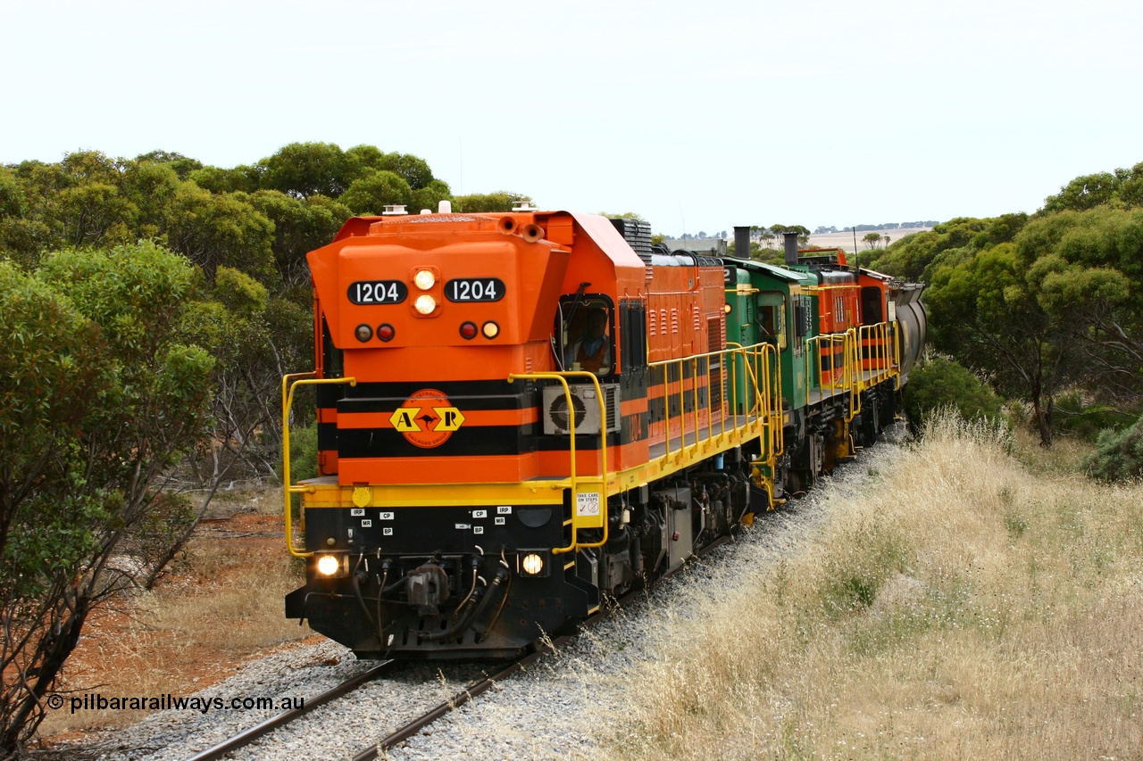 060110 2214
On the curve near the 85 km between Yeelanna and Karkoo, ARG 1200 class unit 1204, a Clyde Engineering EMD model G12C serial 65-428, originally built for the WAGR as the final unit of fourteen A class locomotives in 1965 and sent to the Eyre Peninsula in July 2004 leads an empty grain train. [url=https://goo.gl/maps/7kwfXBE6nS12]Approx. location of image[/url].
Keywords: 1200-class;1204;Clyde-Engineering-Granville-NSW;EMD;G12C;65-428;A-class;A1514;