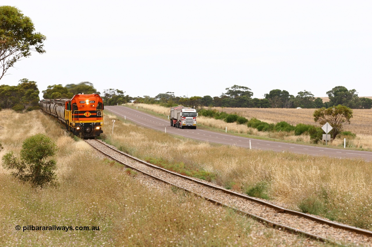 060110 2218
At the Procter Rd grade crossing about halfway between Yeelanna and Karkoo, empty grain train behind ARG 1200 class unit 1204, a Clyde Engineering EMD model G12C serial 65-428, originally built for the WAGR as the final unit of fourteen A class locomotives in 1965 and sent to the Eyre Peninsula in July 2004 and two 830 class AE Goodwin built ALCo model DL531 units with the road competition from a Llewelyn Transport road train with a Freightliner prime mover. [url=https://goo.gl/maps/DzBHRaUezTF2]Approx. location of image[/url].
Keywords: 1200-class;1204;Clyde-Engineering-Granville-NSW;EMD;G12C;65-428;A-class;A1514;