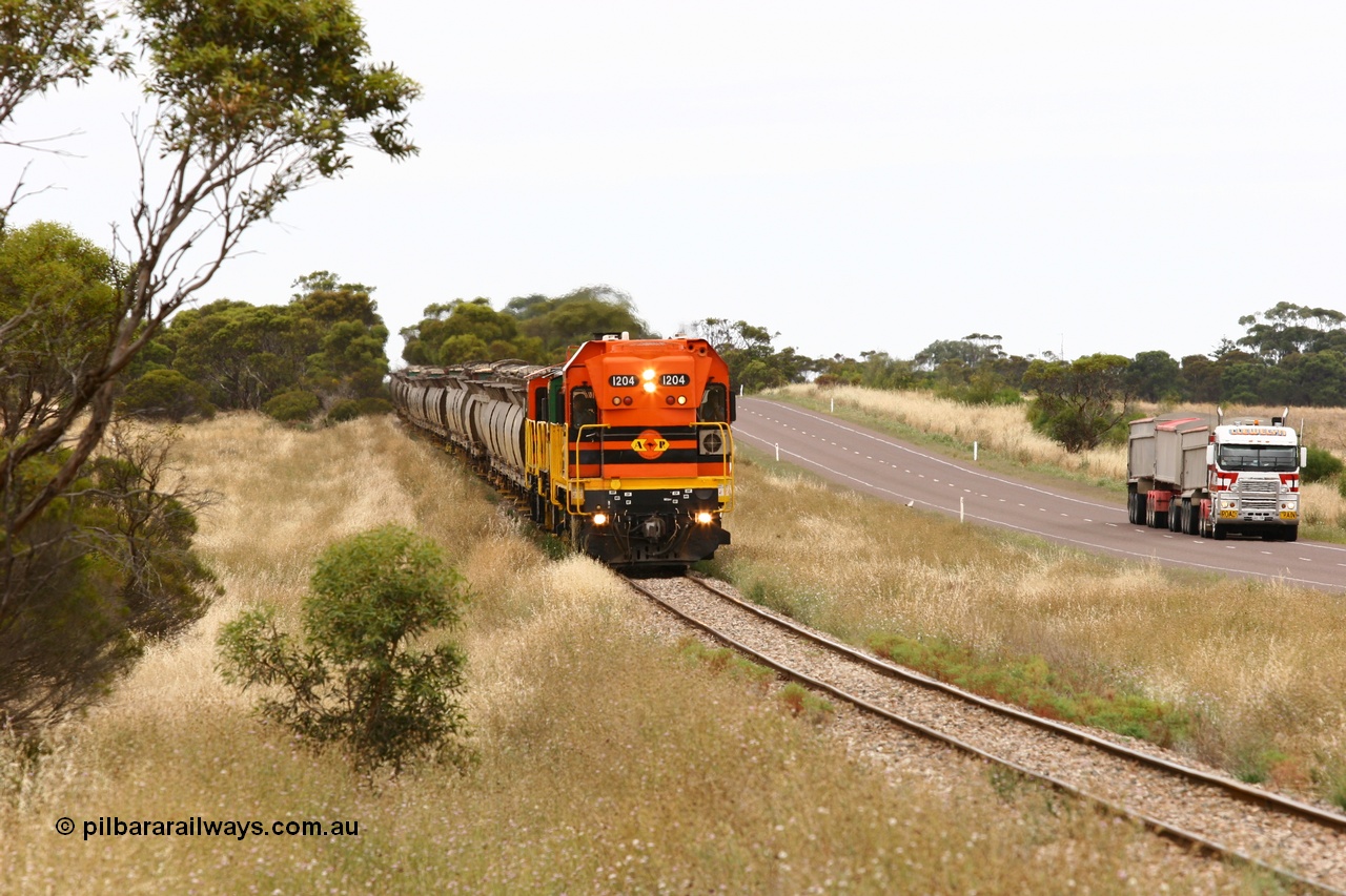 060110 2219
At the Procter Rd grade crossing about halfway between Yeelanna and Karkoo, empty grain train behind ARG 1200 class unit 1204, a Clyde Engineering EMD model G12C serial 65-428, originally built for the WAGR as the final unit of fourteen A class locomotives in 1965 and sent to the Eyre Peninsula in July 2004 and two 830 class AE Goodwin built ALCo model DL531 units with the road competition from a Llewelyn Transport road train with a Freightliner prime mover. [url=https://goo.gl/maps/DzBHRaUezTF2]Approx. location of image[/url].
Keywords: 1200-class;1204;Clyde-Engineering-Granville-NSW;EMD;G12C;65-428;A-class;A1514;