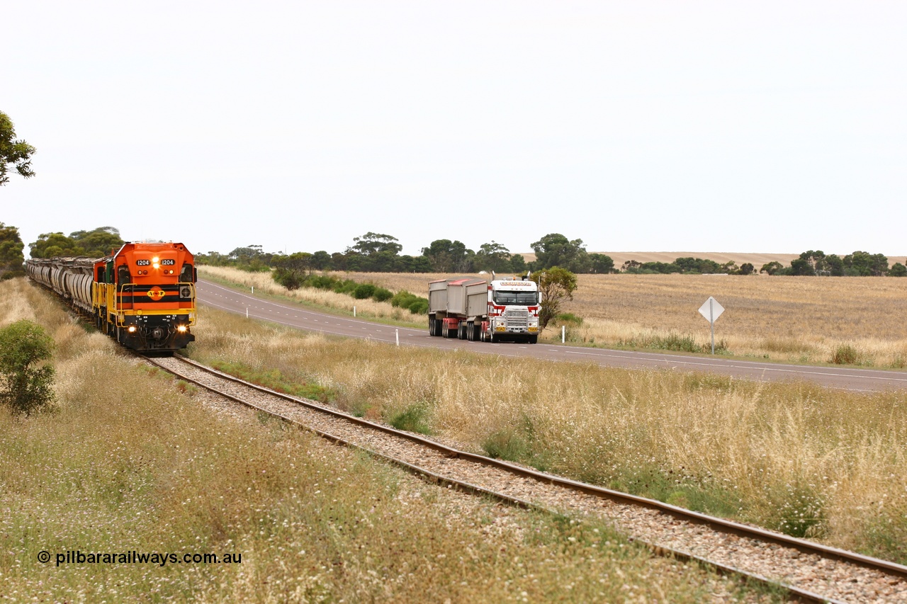 060110 2220
At the Procter Rd grade crossing about halfway between Yeelanna and Karkoo, empty grain train behind ARG 1200 class unit 1204, a Clyde Engineering EMD model G12C serial 65-428, originally built for the WAGR as the final unit of fourteen A class locomotives in 1965 and sent to the Eyre Peninsula in July 2004 and two 830 class AE Goodwin built ALCo model DL531 units with the road competition from a Llewelyn Transport road train with a Freightliner prime mover. [url=https://goo.gl/maps/DzBHRaUezTF2]Approx. location of image[/url].
Keywords: 1200-class;1204;Clyde-Engineering-Granville-NSW;EMD;G12C;65-428;A-class;A1514;
