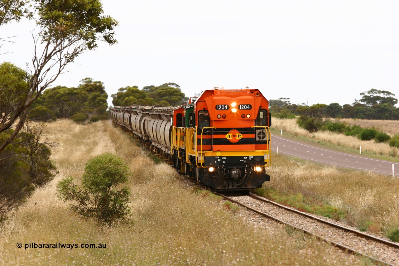 060110 2221
At the Procter Rd grade crossing about halfway between Yeelanna and Karkoo, empty grain train behind ARG 1200 class unit 1204, a Clyde Engineering EMD model G12C serial 65-428, originally built for the WAGR as the final unit of fourteen A class locomotives in 1965 and sent to the Eyre Peninsula in July 2004 and two 830 class AE Goodwin built ALCo model DL531 units 842 serial 84140 ex SAR broad gauge and to Eyre Peninsula in October 1987, and 851 serial 84137 new to Eyre Peninsula in 1962. [url=https://goo.gl/maps/DzBHRaUezTF2]Approx. location of image[/url].
Keywords: 1200-class;1204;Clyde-Engineering-Granville-NSW;EMD;G12C;65-428;A-class;A1514;