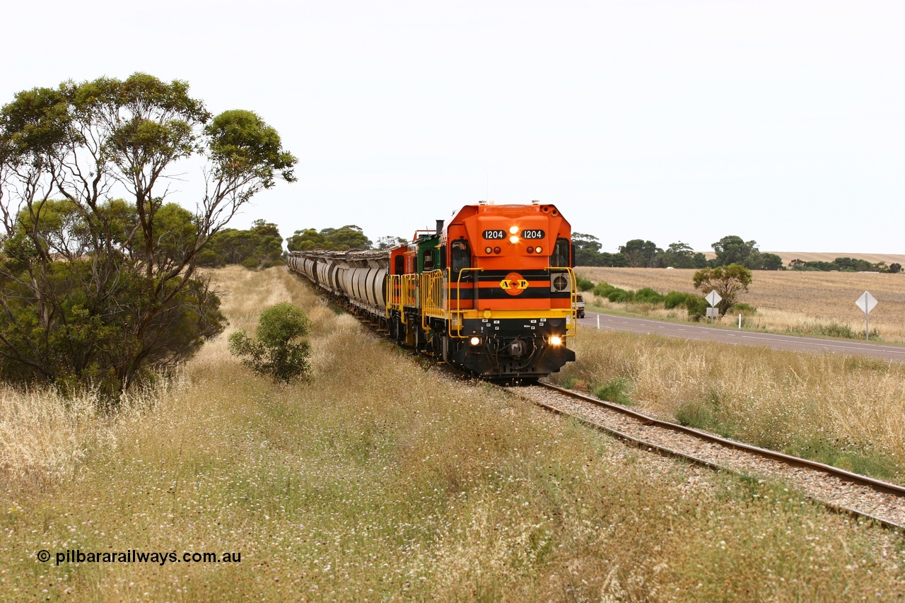 060110 2222
At the Procter Rd grade crossing about halfway between Yeelanna and Karkoo, empty grain train behind ARG 1200 class unit 1204, a Clyde Engineering EMD model G12C serial 65-428, originally built for the WAGR as the final unit of fourteen A class locomotives in 1965 and sent to the Eyre Peninsula in July 2004 and two 830 class AE Goodwin built ALCo model DL531 units 842 serial 84140 ex SAR broad gauge and to Eyre Peninsula in October 1987, and 851 serial 84137 new to Eyre Peninsula in 1962. [url=https://goo.gl/maps/DzBHRaUezTF2]Approx. location of image[/url].
Keywords: 1200-class;1204;Clyde-Engineering-Granville-NSW;EMD;G12C;65-428;A-class;A1514;