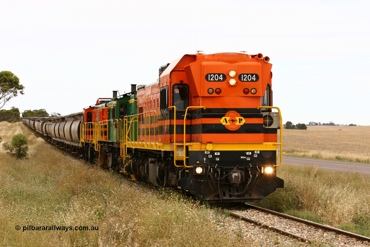 060110 2225
At the Procter Rd grade crossing about halfway between Yeelanna and Karkoo, empty grain train behind ARG 1200 class unit 1204, a Clyde Engineering EMD model G12C serial 65-428, originally built for the WAGR as the final unit of fourteen A class locomotives in 1965 and sent to the Eyre Peninsula in July 2004 and two 830 class AE Goodwin built ALCo model DL531 units 842 serial 84140 ex SAR broad gauge and to Eyre Peninsula in October 1987, and 851 serial 84137 new to Eyre Peninsula in 1962. [url=https://goo.gl/maps/DzBHRaUezTF2]Approx. location of image[/url].
Keywords: 1200-class;1204;Clyde-Engineering-Granville-NSW;EMD;G12C;65-428;A-class;A1514;830-class;842;851;AE-Goodwin;ALCo;DL531;84137;84140;