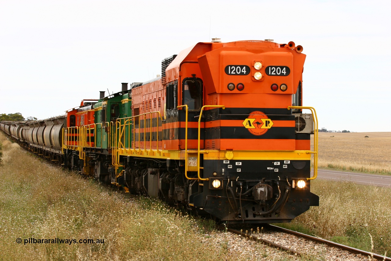 060110 2226
At the Procter Rd grade crossing about halfway between Yeelanna and Karkoo, empty grain train behind ARG 1200 class unit 1204, a Clyde Engineering EMD model G12C serial 65-428, originally built for the WAGR as the final unit of fourteen A class locomotives in 1965 and sent to the Eyre Peninsula in July 2004 and two 830 class AE Goodwin built ALCo model DL531 units 842 serial 84140 ex SAR broad gauge and to Eyre Peninsula in October 1987, and 851 serial 84137 new to Eyre Peninsula in 1962. [url=https://goo.gl/maps/DzBHRaUezTF2]Approx. location of image[/url].
Keywords: 1200-class;1204;Clyde-Engineering-Granville-NSW;EMD;G12C;65-428;A-class;A1514;