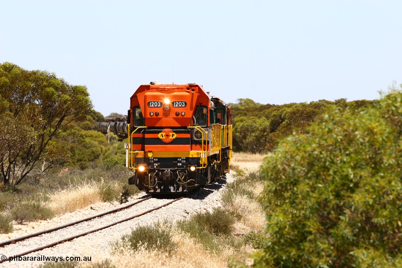 060111 2245
Tooligie, Mac's Road grade crossing at the 110 km, ARG 1200 class unit 1203, a Clyde Engineering EMD model G12C serial 65-427, one of fourteen originally built between 1960-65 for WAGR as their A class A 1513, fitted with dynamic brakes and financed by Western Mining Corporation, started working on the Eyre Peninsula in November 2004 leads an empty grain train north. 11th January 2006.
Keywords: 1200-class;1203;Clyde-Engineering-Granville-NSW;EMD;G12C;65-427;A-class;A1513;