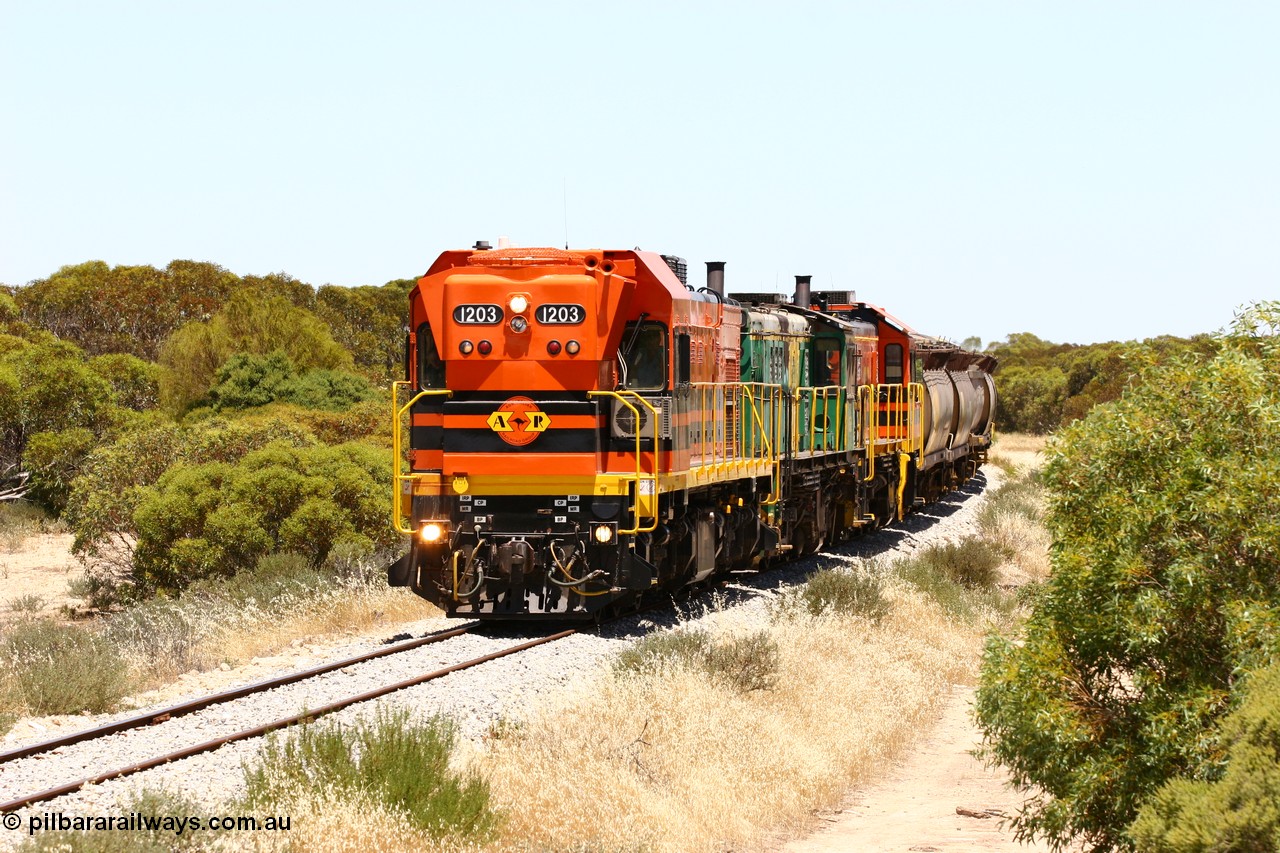 060111 2247
Tooligie, Mac's Road grade crossing at the 110 km, ARG 1200 class unit 1203, a Clyde Engineering EMD model G12C serial 65-427, one of fourteen originally built between 1960-65 for WAGR as their A class A 1513, fitted with dynamic brakes and financed by Western Mining Corporation, started working on the Eyre Peninsula in November 2004 leads an empty grain train north. 11th January 2006.
Keywords: 1200-class;1203;Clyde-Engineering-Granville-NSW;EMD;G12C;65-427;A-class;A1513;