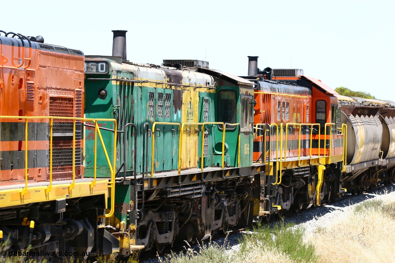 060111 2250
Tooligie, Mac's Road grade crossing at the 110 km, ARG 1200 class unit 1203, a Clyde Engineering EMD model G12C serial 65-427, one of fourteen originally built between 1960-65 for WAGR as their A class A 1513, fitted with dynamic brakes and financed by Western Mining Corporation, started working on the Eyre Peninsula in November 2004 leads an empty grain train north. 11th January 2006.
