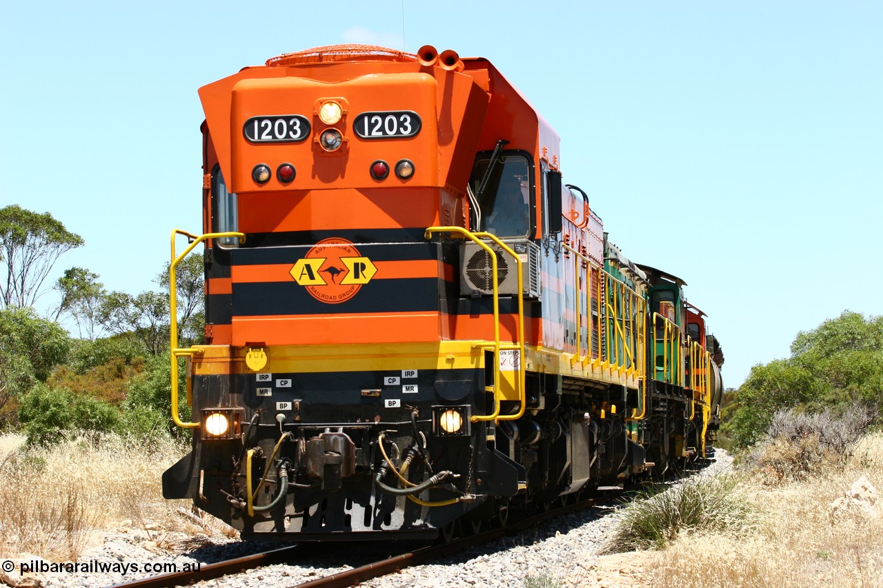 060111 2256
Tooligie, a kilometre south with empty grain train ARG 1200 class unit 1203, a Clyde Engineering EMD model G12C serial 65-427, one of fourteen originally built between 1960-65 for WAGR as their A class A 1513, fitted with dynamic brakes and financed by Western Mining Corporation, started working on the Eyre Peninsula in November 2004 leads an empty grain train north. 11th January 2006.
Keywords: 1200-class;1203;Clyde-Engineering-Granville-NSW;EMD;G12C;65-427;A-class;A1513;