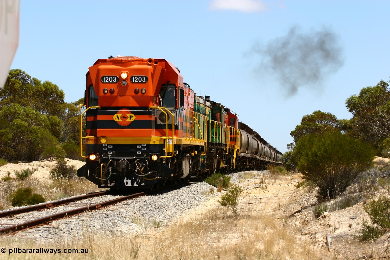 060111 2275
Peachna, Tooligie Hill Road grade crossing, empty grain train running north behind ARG 1200 class unit 1203, a Clyde Engineering EMD model G12C serial 65-427, one of fourteen originally built between 1960-65 for WAGR as their A class A 1513, fitted with dynamic brakes and financed by Western Mining Corporation, started working on the Eyre Peninsula in November 2004. 11th January 2006.
Keywords: 1200-class;1203;Clyde-Engineering-Granville-NSW;EMD;G12C;65-427;A-class;A1513;