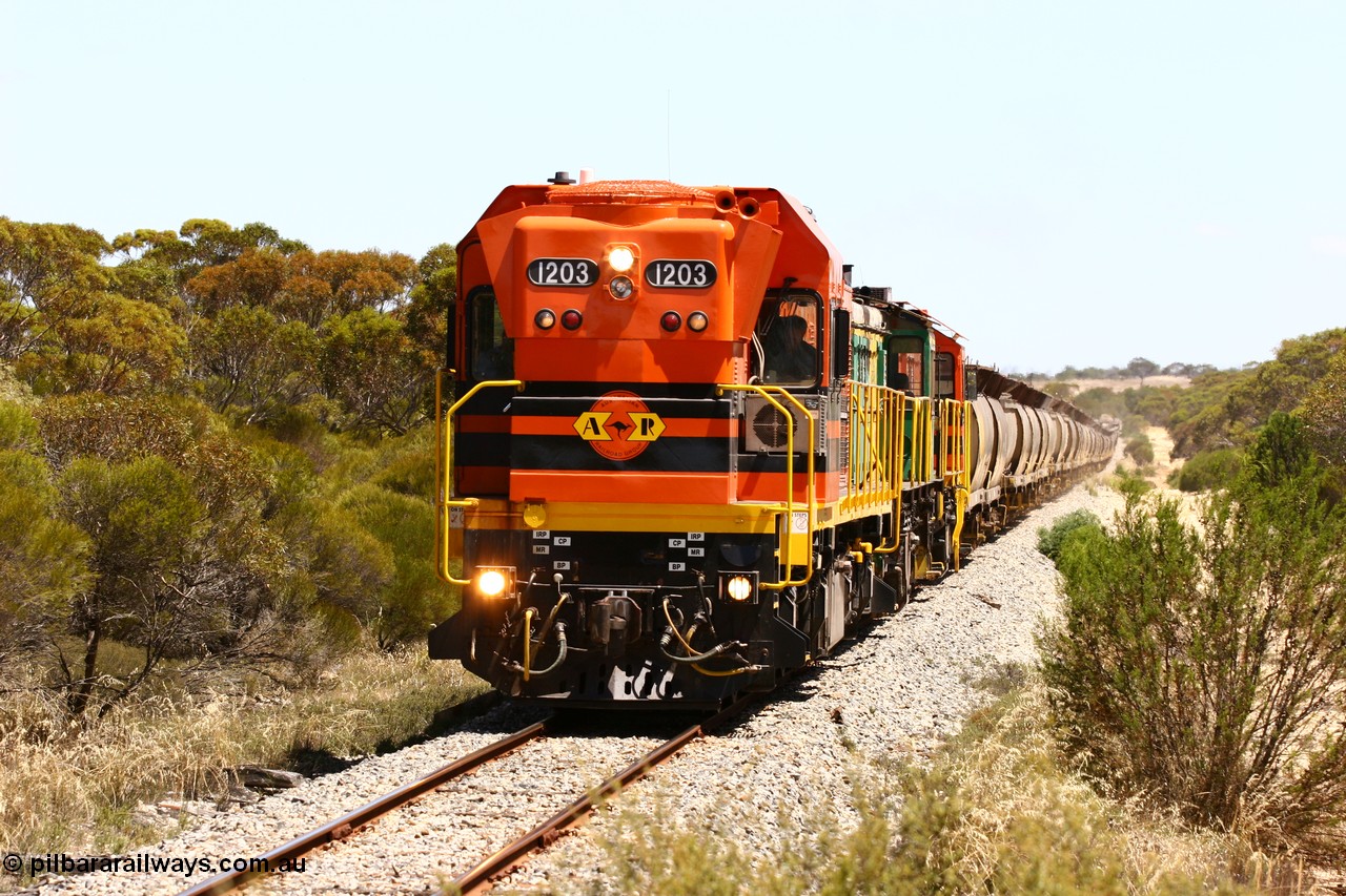 060111 2292
Warrachie, ARG 1200 class unit 1203, a Clyde Engineering EMD model G12C serial 65-427, one of fourteen originally built between 1960-65 for WAGR as their A class A 1513, fitted with dynamic brakes and financed by Western Mining Corporation, started working on the Eyre Peninsula in November 2004 leads an empty grain train between Murdinga and Lock. 11th January 2006.
Keywords: 1200-class;1203;Clyde-Engineering-Granville-NSW;EMD;G12C;65-427;A-class;A1513;