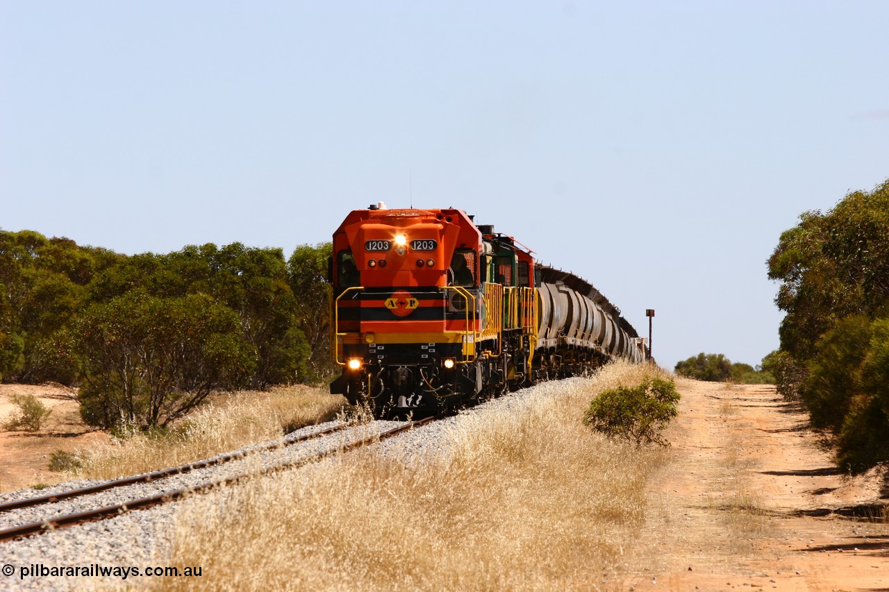 060111 2295
Lock, ARG 1200 class unit 1203, a Clyde Engineering EMD model G12C serial 65-427, one of fourteen originally built between 1960-65 for WAGR as their A class A 1513, fitted with dynamic brakes and financed by Western Mining Corporation, started working on the Eyre Peninsula in November 2004 with two ALCO units 850 and 905 drag their grain train over the grade past the location sign and down into Lock. 11th January 2006.
Keywords: 1200-class;1203;Clyde-Engineering-Granville-NSW;EMD;G12C;65-427;A-class;A1513;