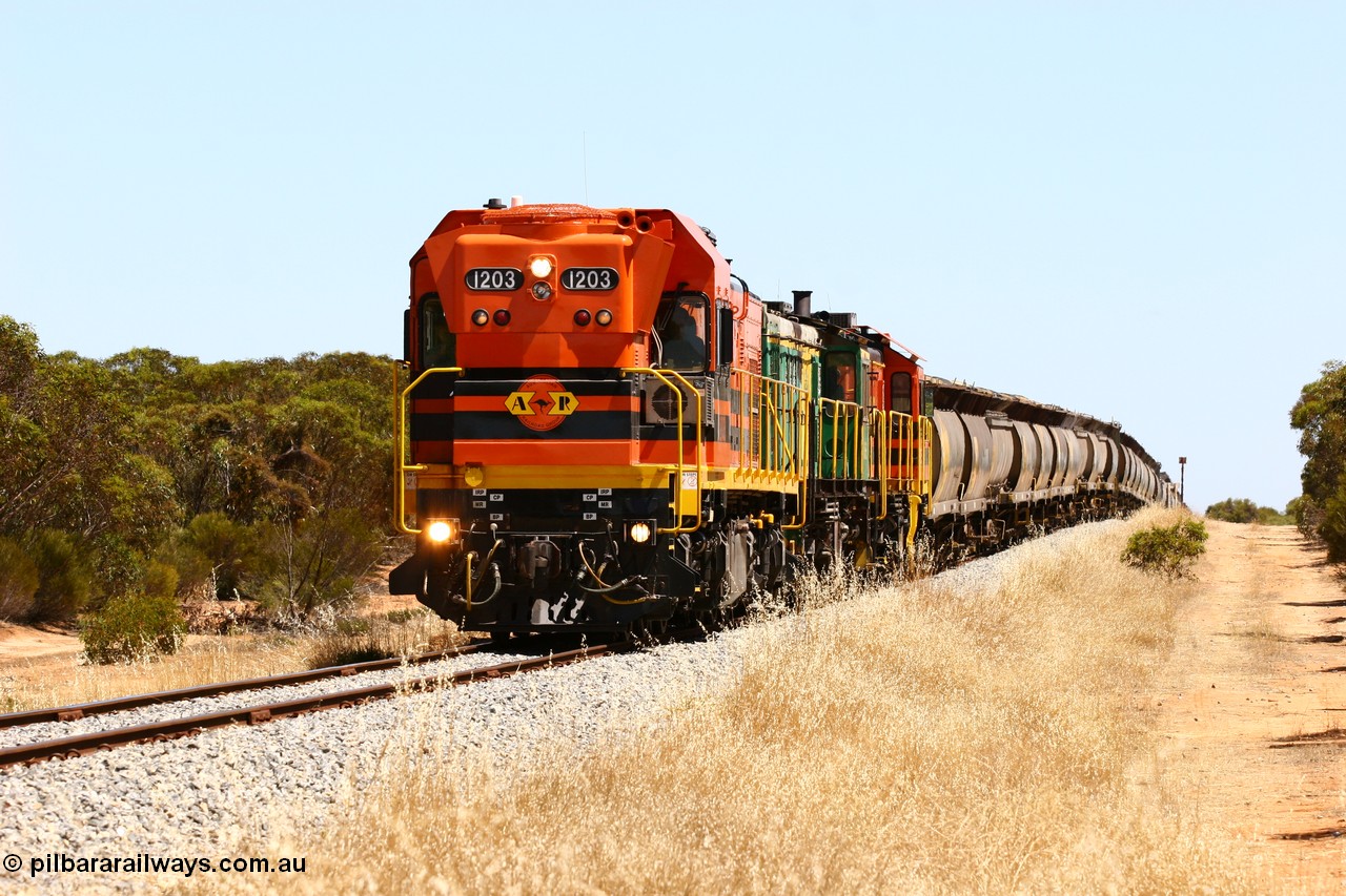 060111 2296
Lock, ARG 1200 class unit 1203, a Clyde Engineering EMD model G12C serial 65-427, one of fourteen originally built between 1960-65 for WAGR as their A class A 1513, fitted with dynamic brakes and financed by Western Mining Corporation, started working on the Eyre Peninsula in November 2004 with two ALCO units 850 and 905 drag their grain train over the grade past the location sign and down into Lock. 11th January 2006.
Keywords: 1200-class;1203;Clyde-Engineering-Granville-NSW;EMD;G12C;65-427;A-class;A1513;