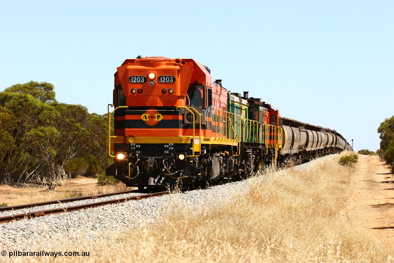060111 2297
Lock, ARG 1200 class unit 1203, a Clyde Engineering EMD model G12C serial 65-427, one of fourteen originally built between 1960-65 for WAGR as their A class A 1513, fitted with dynamic brakes and financed by Western Mining Corporation, started working on the Eyre Peninsula in November 2004 with two ALCO units 850 and 905 drag their grain train over the grade past the location sign and down into Lock. 11th January 2006.
Keywords: 1200-class;1203;Clyde-Engineering-Granville-NSW;EMD;G12C;65-427;A-class;A1513;