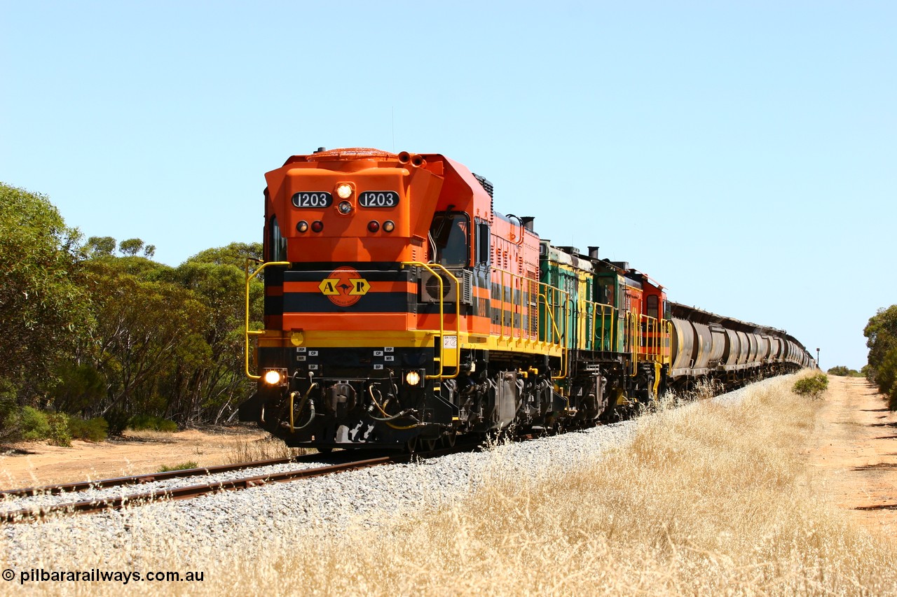 060111 2298
Lock, ARG 1200 class unit 1203, a Clyde Engineering EMD model G12C serial 65-427, one of fourteen originally built between 1960-65 for WAGR as their A class A 1513, fitted with dynamic brakes and financed by Western Mining Corporation, started working on the Eyre Peninsula in November 2004 with two ALCO units 850 and 905 drag their grain train over the grade past the location sign and down into Lock. 11th January 2006.
Keywords: 1200-class;1203;Clyde-Engineering-Granville-NSW;EMD;G12C;65-427;A-class;A1513;