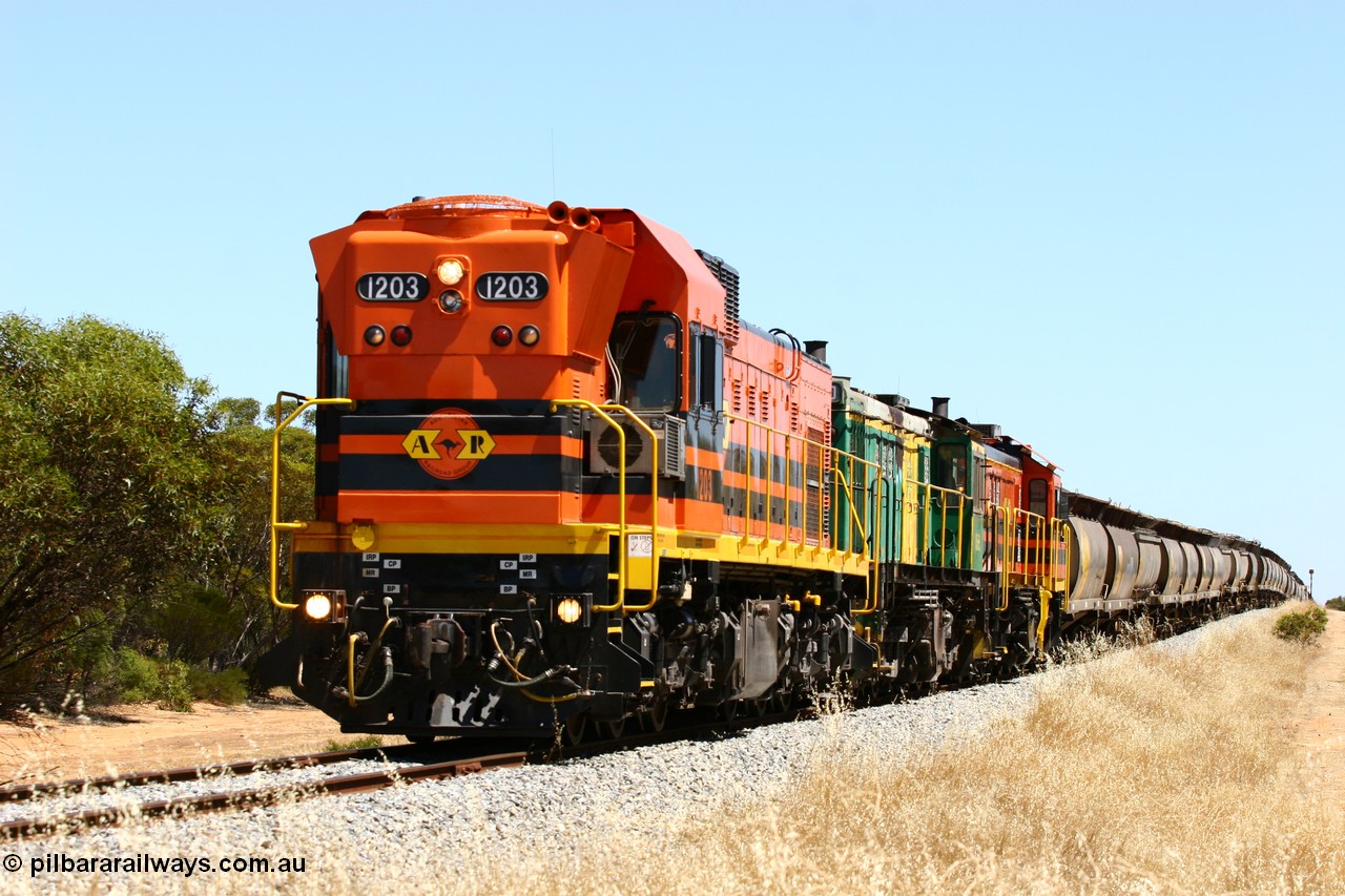 060111 2300
Lock, ARG 1200 class unit 1203, a Clyde Engineering EMD model G12C serial 65-427, one of fourteen originally built between 1960-65 for WAGR as their A class A 1513, fitted with dynamic brakes and financed by Western Mining Corporation, started working on the Eyre Peninsula in November 2004 with two ALCO units 850 and 905 drag their grain train over the grade past the location sign and down into Lock. 11th January 2006.
Keywords: 1200-class;1203;Clyde-Engineering-Granville-NSW;EMD;G12C;65-427;A-class;A1513;
