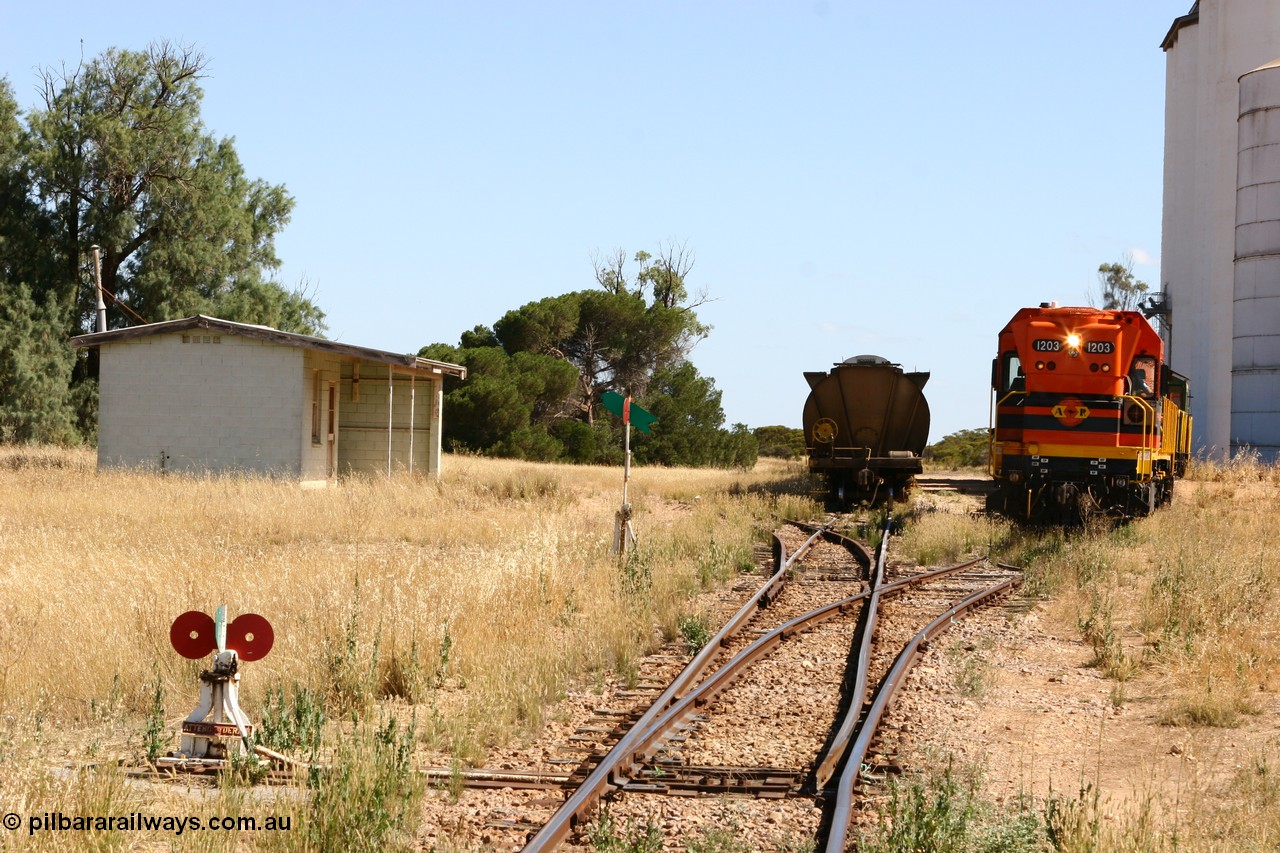 060111 2323
Warramboo, located at the 190.2 km and opened with the line in May 1913, with now disused station building on the left, Clyde Engineering built EMD G12C model loco 1203 serial 65-427 shunts empty grain waggons into the grain loop for loading. 11th January 2006.
Keywords: 1200-class;1203;Clyde-Engineering-Granville-NSW;EMD;G12C;65-427;A-class;A1513;