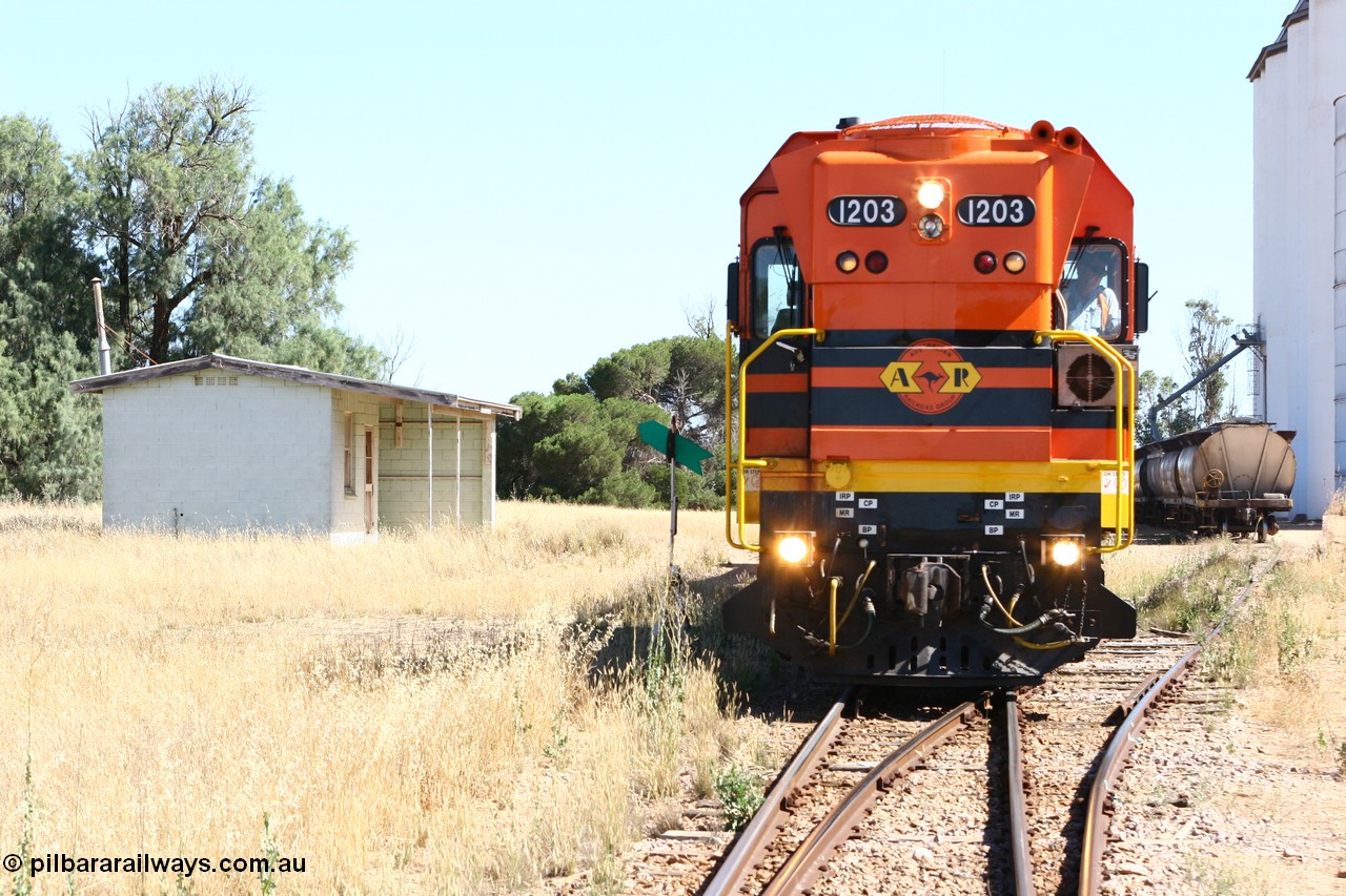 060111 2329
Warramboo, located at the 190.2 km and opened with the line in May 1913, with now disused station building on the left, Clyde Engineering built EMD G12C model loco 1203 serial 65-427 stands on the mainline as loading on the grain siding has started. 11th January 2006.
Keywords: 1200-class;1203;Clyde-Engineering-Granville-NSW;EMD;G12C;65-427;A-class;A1513;