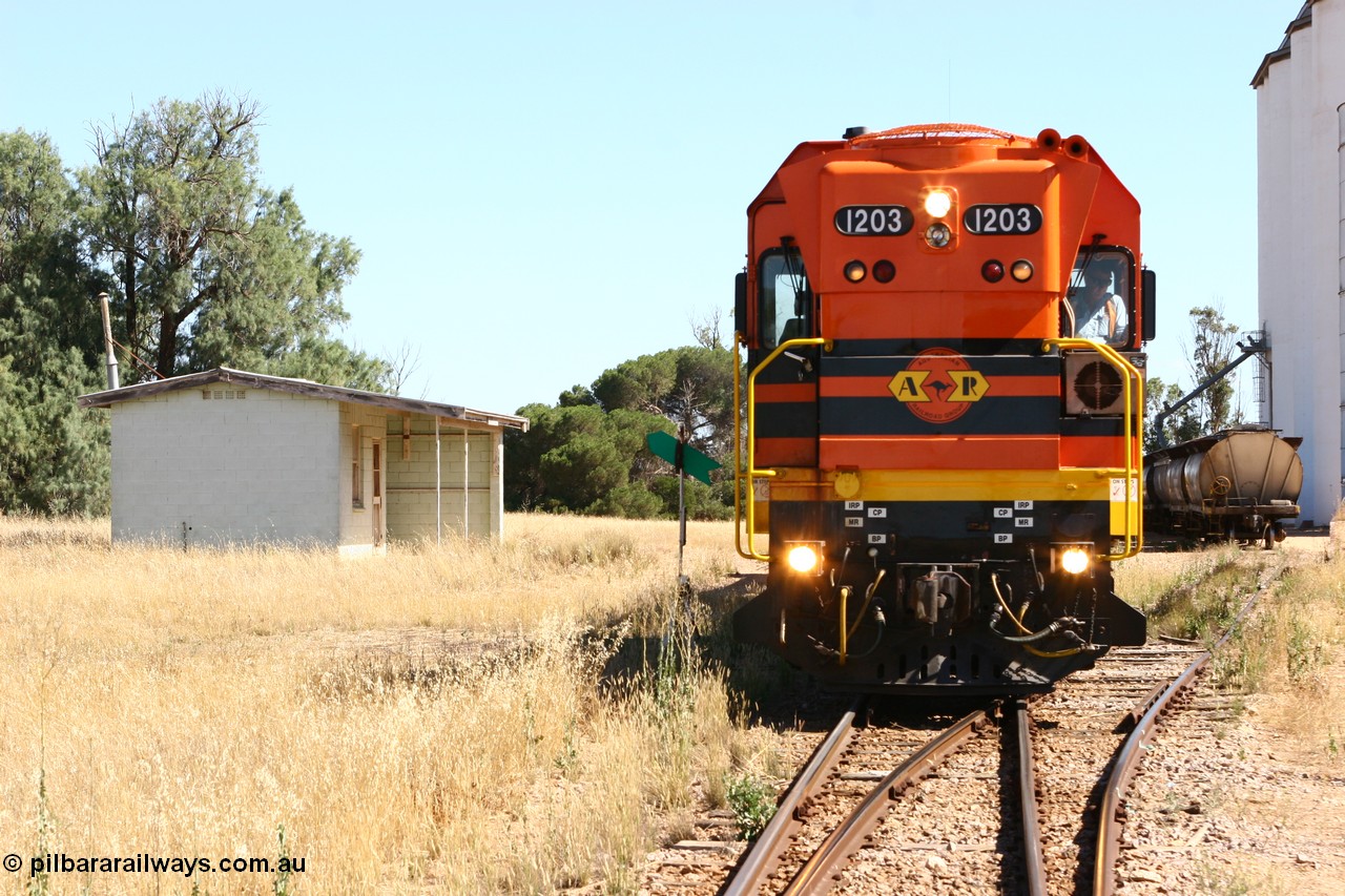 060111 2331
Warramboo, located at the 190.2 km and opened with the line in May 1913, with now disused station building on the left, Clyde Engineering built EMD G12C model loco 1203 serial 65-427 stands on the mainline as loading on the grain siding has started. 11th January 2006.
Keywords: 1200-class;1203;Clyde-Engineering-Granville-NSW;EMD;G12C;65-427;A-class;A1513;