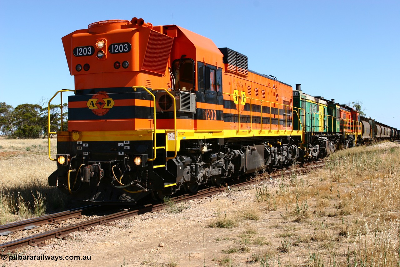 060111 2334
Warramboo, located at the 190.2 km and opened with the line in May 1913, with now disused station building on the left, Clyde Engineering built EMD G12C model loco 1203 serial 65-427 stands on the mainline as loading on the grain siding has started. 11th January 2006.
Keywords: 1200-class;1203;Clyde-Engineering-Granville-NSW;EMD;G12C;65-427;A-class;A1513;