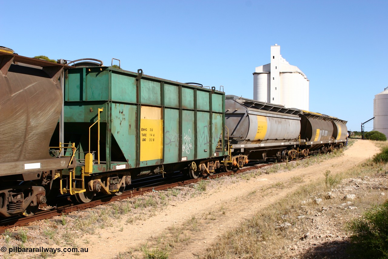 060111 2353
Kyancutta, this shot shows three of the types of waggon used, former Australian National narrow gauge ENHG type bogie grain waggon ENHG 3, originally built by Moore Road Ind, Victoria as NB type NB 1398 ballast hopper for the NAR, then to standard gauge in 1975 as BA type BA 1540, recoded to AHTY in 1980, to EP April 1984, recoded to NHG type NHG 6 in May 1984, then again to ENHT type ENHT 6 in March 1985 and further rebuilt forming one half of ENHG type grain waggon in August 1986. The conversion involved splicing two AHTY-ENHT type waggons together at Port Lincoln workshops, an HCN type HCN 4, was modified at Islington Workshops in 1978-80 and started life as a Tulloch built NHB type iron ore hopper for the CR on the North Australia Railway in 1968-69, and an SAR built HAN type as they are shunted back into the grain siding for loading. 11th January 2006.
Keywords: ENHG-type;ENHG3;Moore-Road-Ind-Victoria;NB-type;NB1398;BA-type;BA1540;AHTY-type;NHG-type;NHG6;ENHT-type;