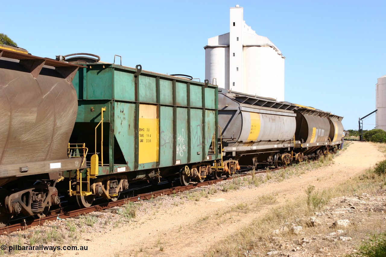 060111 2354
Kyancutta, this shot shows three of the types of waggon used, former Australian National narrow gauge ENHG type bogie grain waggon ENHG 3, originally built by Moore Road Ind, Victoria as NB type NB 1398 ballast hopper for the NAR, then to standard gauge in 1975 as BA type BA 1540, recoded to AHTY in 1980, to EP April 1984, recoded to NHG type NHG 6 in May 1984, then again to ENHT type ENHT 6 in March 1985 and further rebuilt forming one half of ENHG type grain waggon in August 1986. The conversion involved splicing two AHTY-ENHT type waggons together at Port Lincoln workshops, an HCN type HCN 4 was modified at Islington Workshops in 1978-80 and started life as a Tulloch built NHB type iron ore hopper for the CR on the North Australia Railway in 1968-69, and an SAR built HAN type as they are shunted back into the grain siding for loading. 11th January 2006.
Keywords: ENHG-type;ENHG3;Moore-Road-Ind-Victoria;NB-type;NB1398;BA-type;BA1540;AHTY-type;NHG-type;NHG6;ENHT-type;