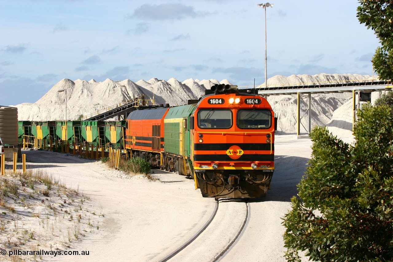 060113 2432
Thevenard, at the Gypsum Resources Australian (GRA) gypsum unloading site, 1604 leads a triple consist of Clyde Engineering EMD JL22C model 1600 / NJ class combination of 1604 serial 71-731 and originally NJ 4, NJ 3 serial 71-730 and 1601 serial 71-728 class leader NJ 1, all three units started on the Central Australia Railway in 1971 and were transferred to the Eyre Peninsula in 1981. 1604 and 1601 both renumbered in 2004. Friday 13th January 2006.
Keywords: 1600-class;1604;Clyde-Engineering-Granville-NSW;EMD;JL22C;71-731;NJ-class;NJ4;