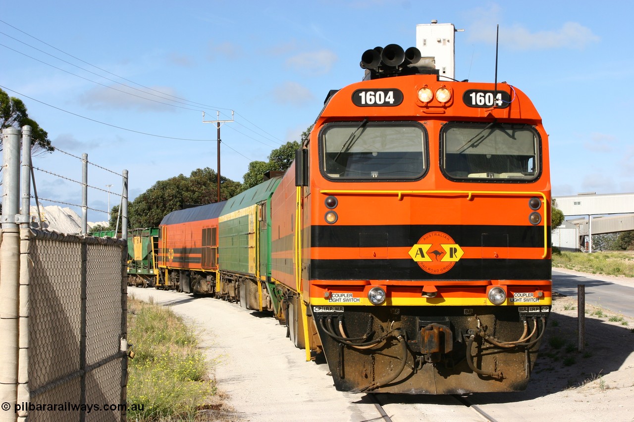 060113 2438
Thevenard, at the Gypsum Resources Australian (GRA) gypsum unloading site, 1604 leads a triple consist of Clyde Engineering EMD JL22C model 1600 / NJ class combination of 1604 serial 71-731 and originally NJ 4, NJ 3 serial 71-730 and 1601 serial 71-728 class leader NJ 1, all three units started on the Central Australia Railway in 1971 and were transferred to the Eyre Peninsula in 1981. 1604 and 1601 both renumbered in 2004. Friday 13th January 2006.
Keywords: 1600-class;1604;Clyde-Engineering-Granville-NSW;EMD;JL22C;71-731;NJ-class;NJ4;