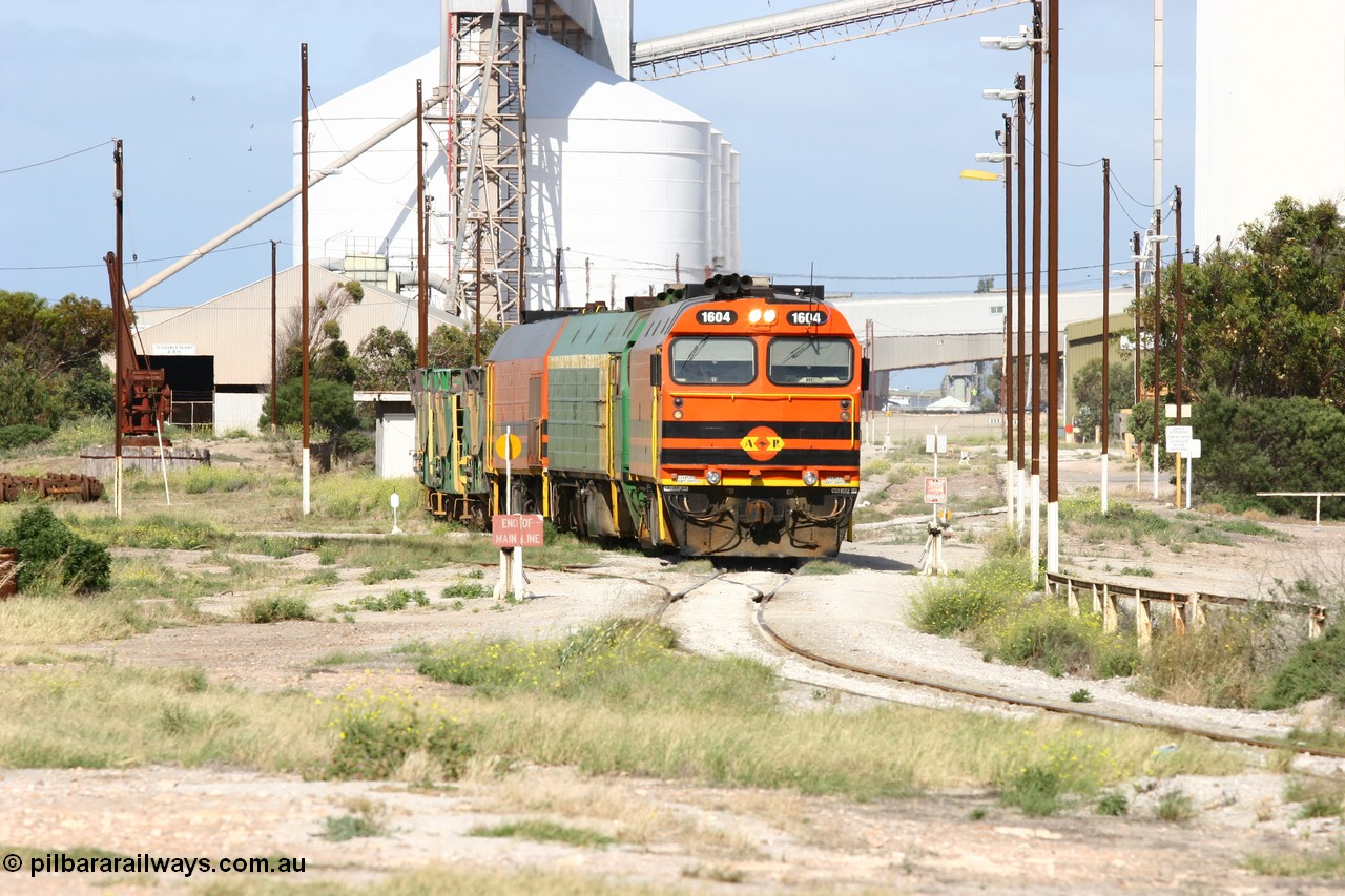 060113 2463
Thevenard, narrow gauge loco 1604 with a fresh crew depart the yard with empty train 6DD3, 1604 leads a triple consist of Clyde Engineering built EMD JL22C model 1600 / NJ class combination of 1604 serial 71-731 and originally NJ 4, NJ 3 serial 71-730 and 1601 serial 71-728 the original class leader NJ 1, all three units started on the Central Australia Railway in 1971 and were transferred to the Eyre Peninsula in 1981. 1604 and 1601 both renumbered in 2004. 13th January 2006.
Keywords: 1600-class;1604;Clyde-Engineering-Granville-NSW;EMD;JL22C;71-731;NJ-class;NJ4;