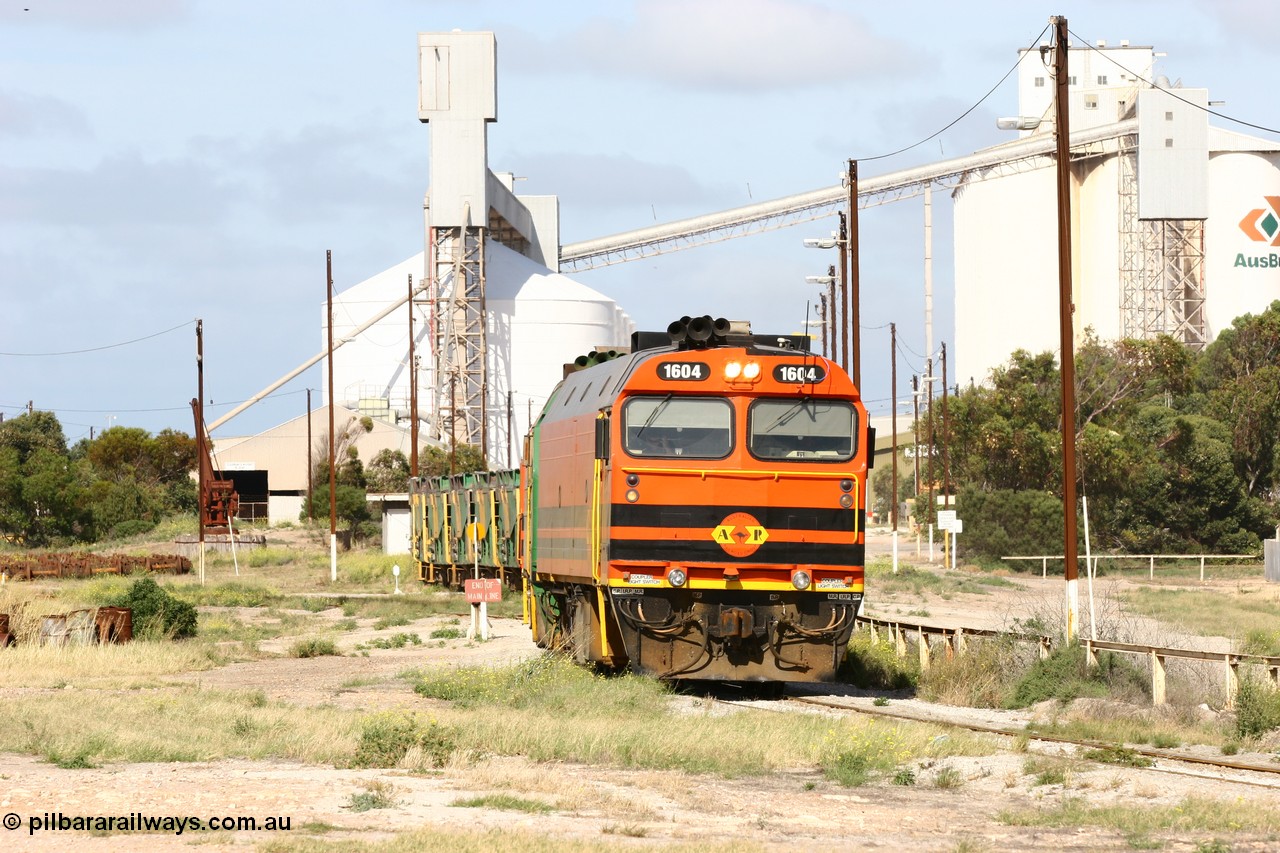 060113 2466
Thevenard, narrow gauge loco 1604 departs the yard with empty train 6DD3, 1604 leads a triple consist of Clyde Engineering built EMD JL22C model 1600 / NJ class combination of 1604 serial 71-731 and originally NJ 4, NJ 3 serial 71-730 and 1601 serial 71-728 the original class leader NJ 1, all three units started on the Central Australia Railway in 1971 and were transferred to the Eyre Peninsula in 1981. 1604 and 1601 both renumbered in 2004. 13th January 2006.
Keywords: 1600-class;1604;Clyde-Engineering-Granville-NSW;EMD;JL22C;71-731;NJ-class;NJ4;