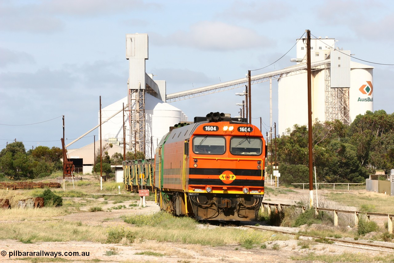 060113 2467
Thevenard, narrow gauge loco 1604 departs the yard with empty train 6DD3, 1604 leads a triple consist of Clyde Engineering built EMD JL22C model 1600 / NJ class combination of 1604 serial 71-731 and originally NJ 4, NJ 3 serial 71-730 and 1601 serial 71-728 the original class leader NJ 1, all three units started on the Central Australia Railway in 1971 and were transferred to the Eyre Peninsula in 1981. 1604 and 1601 both renumbered in 2004. 13th January 2006.
Keywords: 1600-class;1604;Clyde-Engineering-Granville-NSW;EMD;JL22C;71-731;NJ-class;NJ4;